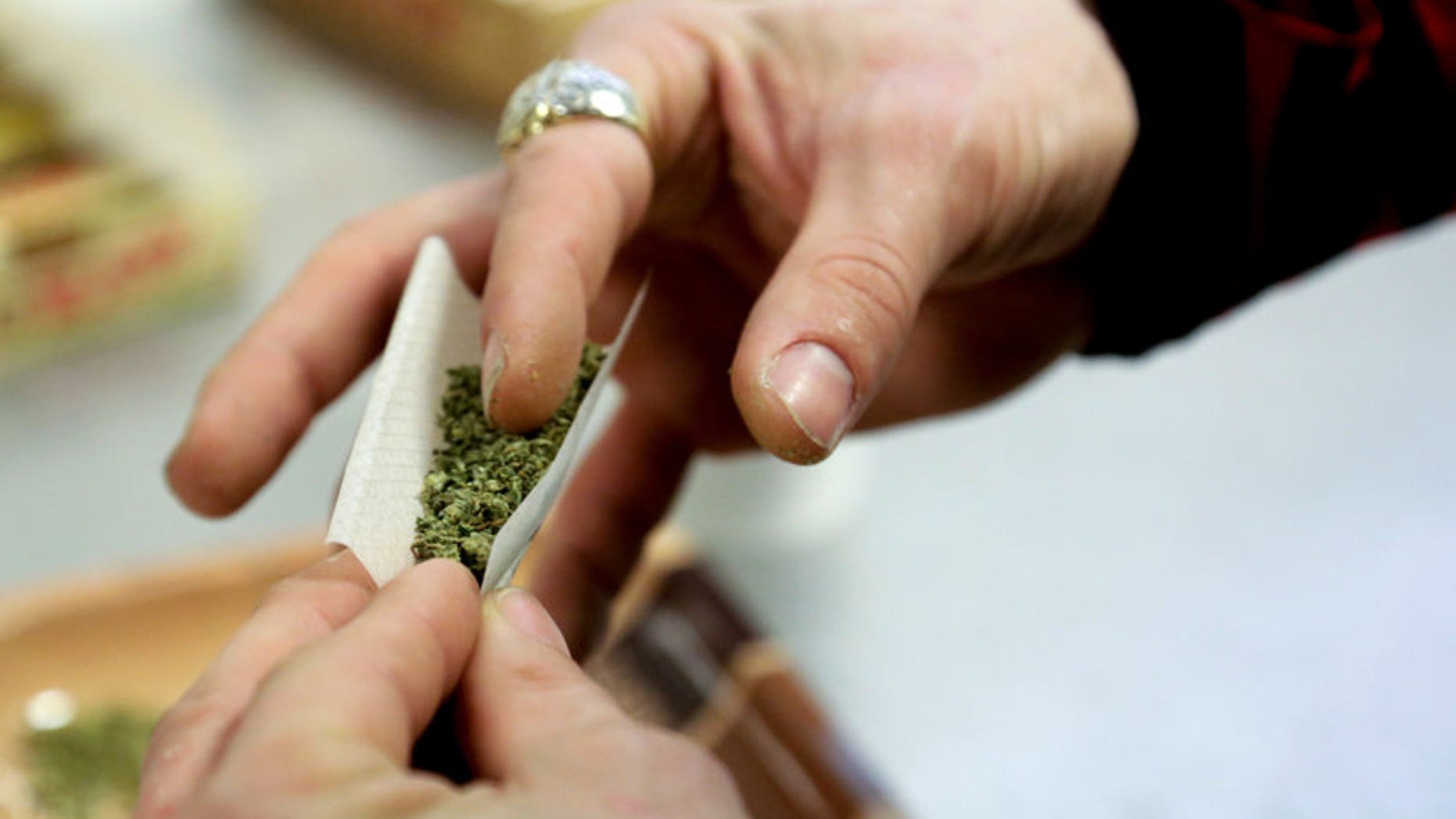 A participant practices rolling a joint at the Cannabis Carnivalus 4/20 event in Seattle