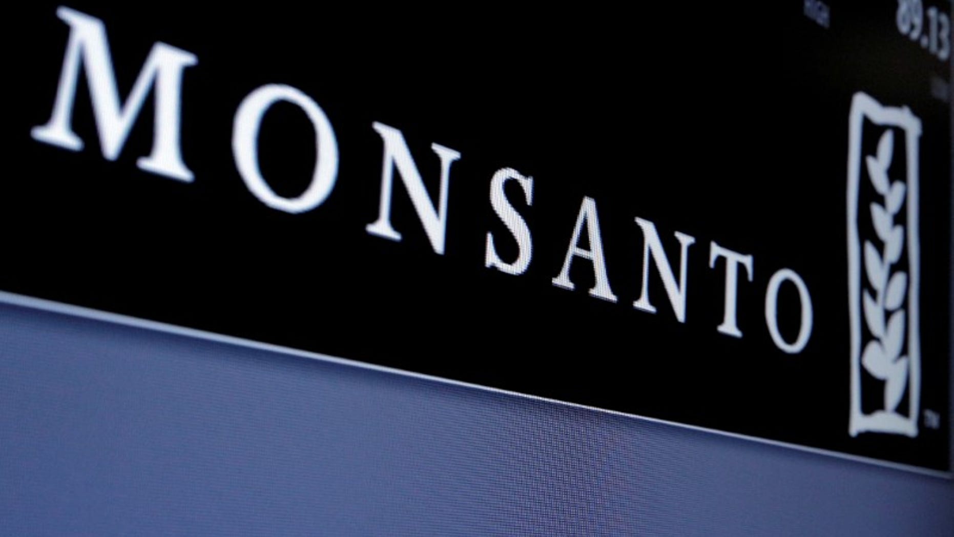 Monsanto logo is displayed on a screen where the stock is traded on the floor of the NYSE