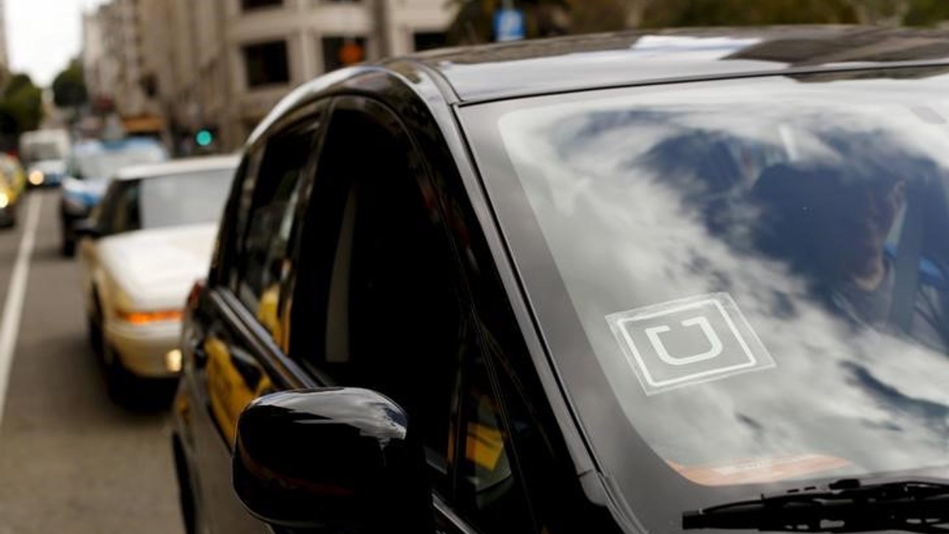 The Uber logo is seen on a vehicle near Union Square in San Francisco, California, U.S. May 7, 2015. REUTERS/Robert Galbraith/File Photo