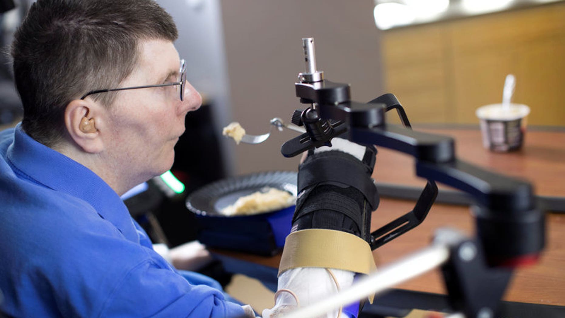 Bill Kochevar is using computer-brain interface technology and an electrical stimulation system to move his own arm after eight years of paralysis, in this undated handout photo