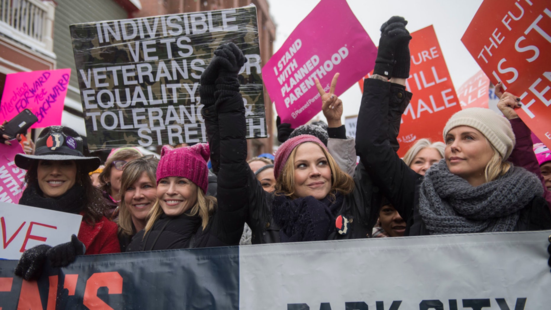 Actresses Chelsea Handler and Charlize Theron, right, participate in the "Women's March On Main" during the 2017 Sundance Film Festival on Saturday, Jan. 21, 2017, in Park City, Utah. (Photo by Arthur Mola/Invision/AP)