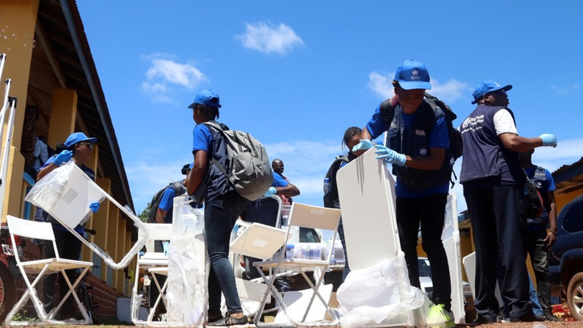 World Health Organization workers prepare a centre for vaccination in the port city of Mbandaka