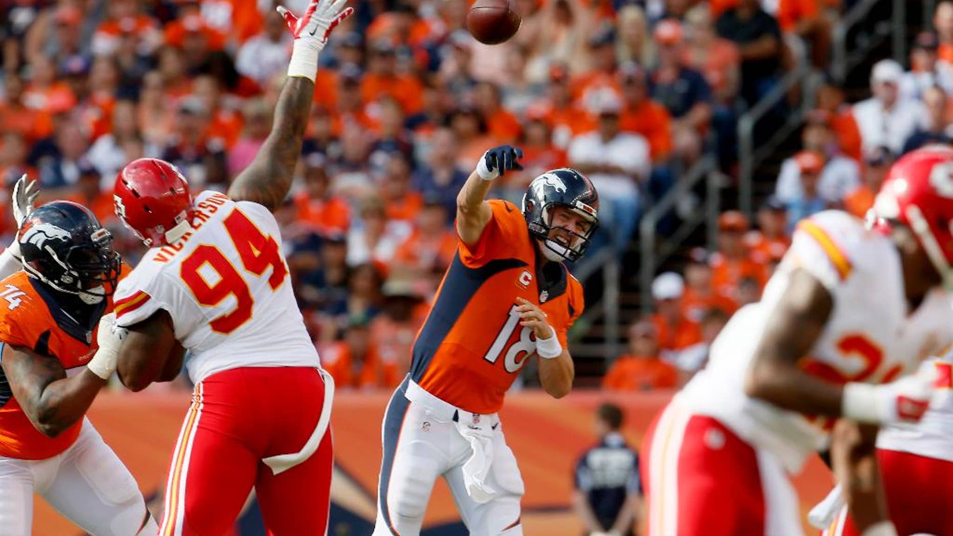 Denver Broncos quarterback Peyton Manning (18) throws against the Kansas City Chiefs during the second half of an NFL football game, Sunday, Sept. 14, 2014, in Denver. (AP Photo/Joe Mahoney)