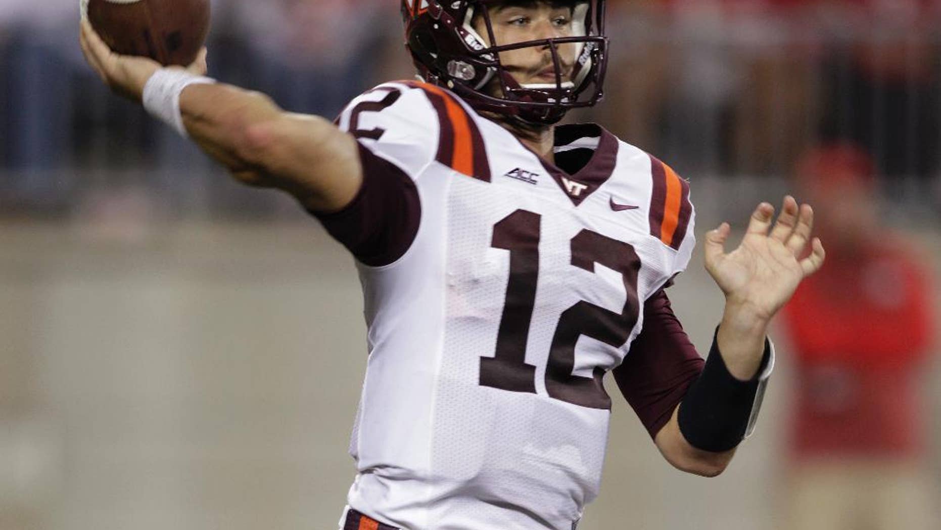 Virginia Tech quarterback Michael Brewer drops back to pass against Ohio State during the fourth quarter of an NCAA college football game Saturday, Sept. 6, 2014, in Columbus, Ohio. Virginia Tech defeated Ohio State 35-21. (AP Photo/Jay LaPrete)