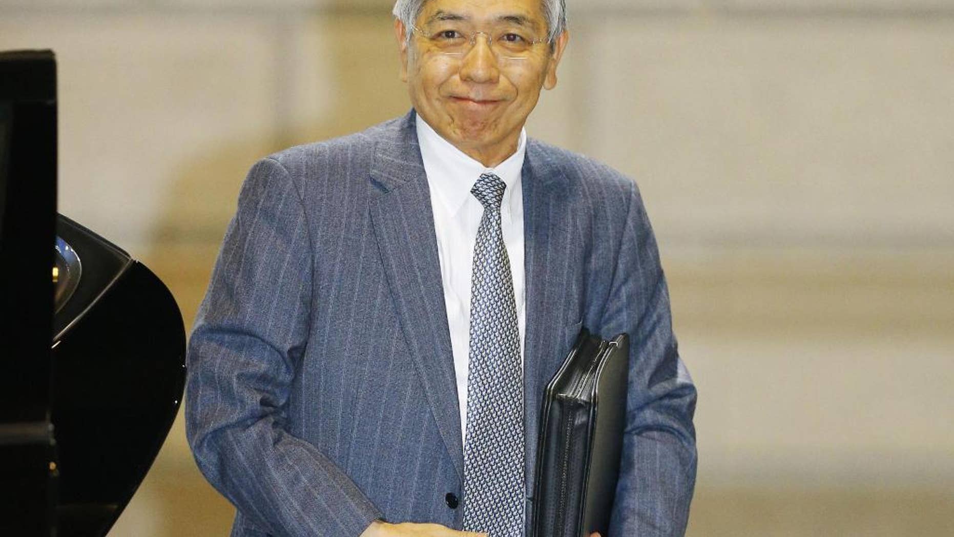 Governor of the Bank of Japan Haruhiko Kuroda arrives at its head office in Tokyo Friday, Oct. 30, 2015. Japan has reported that its core inflation rate, which excludes volatile food prices, edged down 0.1 percent in September. Slow progress toward a 2 percent inflation goal has raised expectations that the central bank might announce an expansion of its already lavish monetary easing at a policy meeting that wraps up later in the day. (Kyodo News via AP)