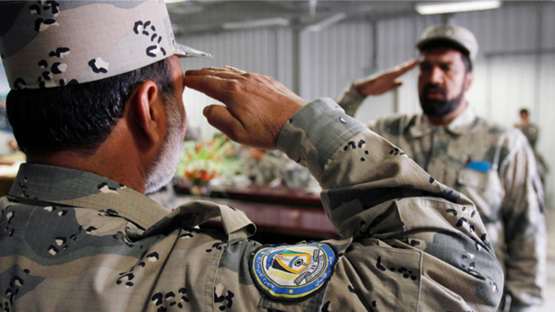 Jan. 31: An Afghan newly graduated border police officer, right, salutes his commander before receiving his certification during a graduation ceremony at the border police headquarter in Jalalabad, Nangarhar province east of Kabul, Afghanistan.