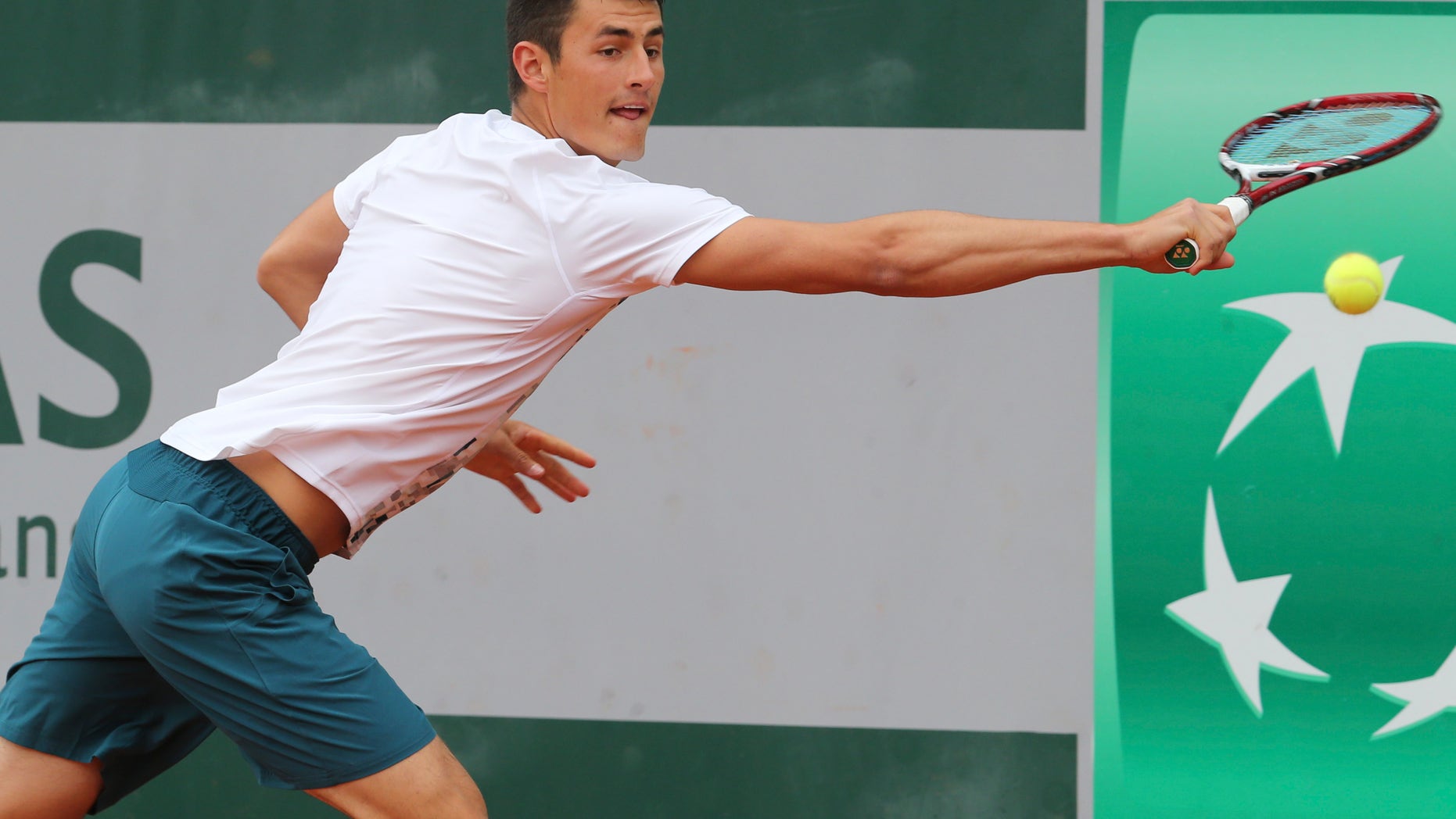 Australia's Bernard Tomic returns against Romania's Victor Hanescu during their first round match at the French Open tennis tournament, at Roland Garros stadium in Paris, Tuesday, May 28, 2013. (AP Photo/Michel Euler)
