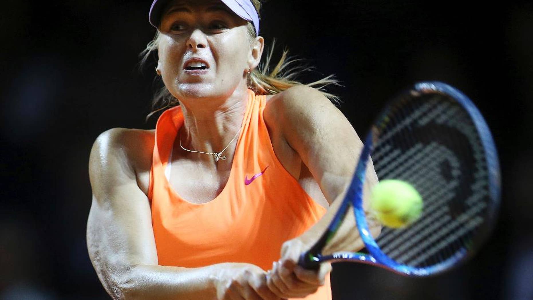 FILE - A Wednesday, April 26, 2017 file photo showing Russia's Maria Sharapova hitting a backhand against Italy's Roberta Vinci at the Porsche Tennis Grand Prix in Stuttgart, Germany. Maria Sharapova recovered from a shaky opening to defeat Mirjana Lucic-Baroni of Croatia 4-6, 6-4, 6-0 in the first round of the Madrid Open on Sunday, May 7, 2017, setting up a match against Eugenie Bouchard, one of the most outspoken players against her return from doping. (AP Photo/Michael Probst, File)