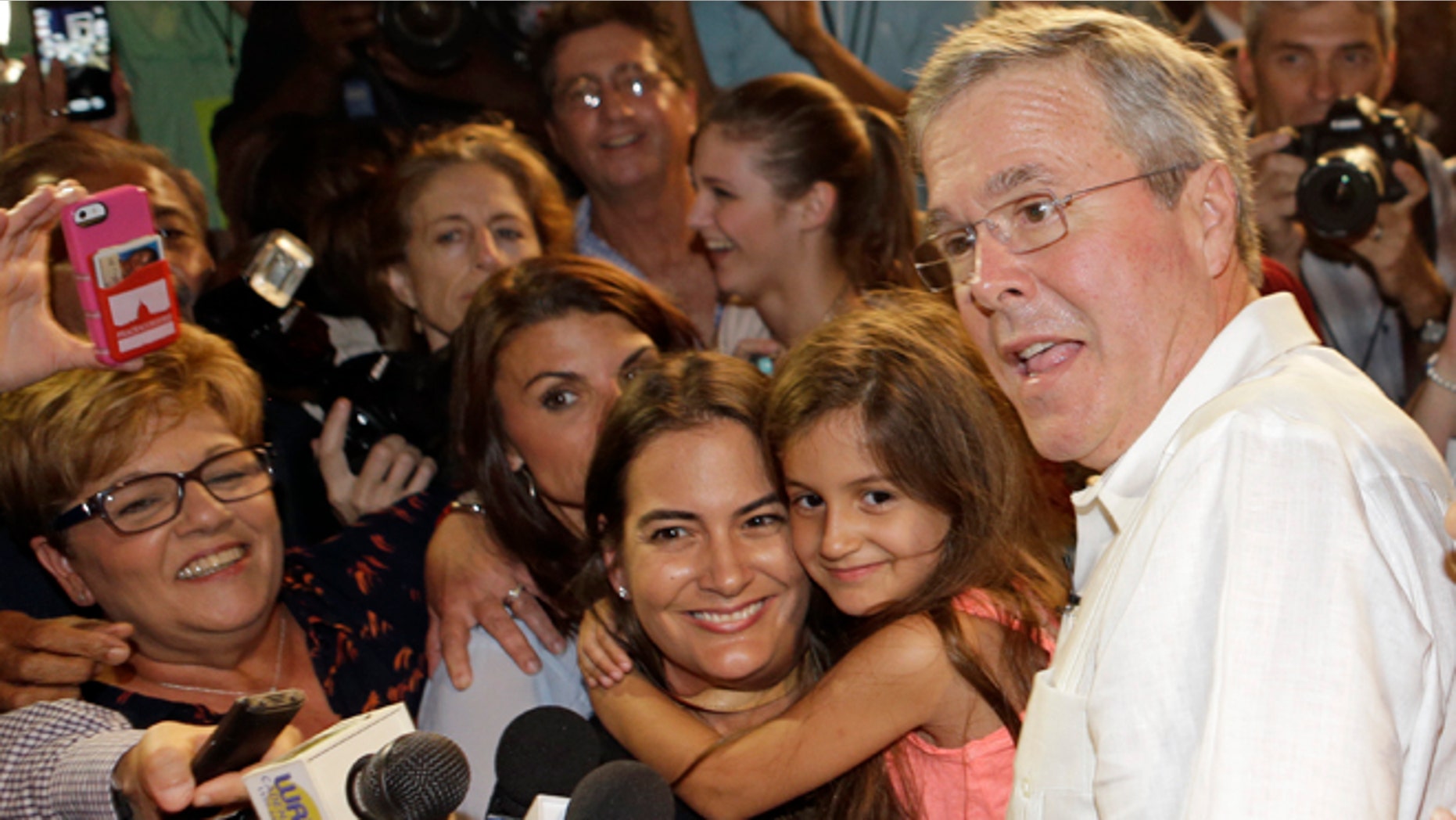 Former Florida Gov. Jeb Bush poses with supporters for photos during a fundraiser, Monday, May 18, 2015, in Sweetwater, Fla. (AP Photo/Alan Diaz)