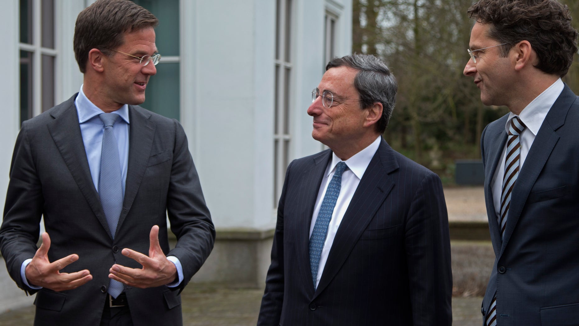 Dutch Prime Minister Mark Rutte, European Central Bank chief Mario Draghi, and Eurogroup President and Dutch Finance minister Jeroen Dijsselbloem, from left to right, pose for photographers prior to a meeting in The Hague, Netherlands, Monday April 15, 2013. Draghi will address Amsterdam students later in the day on the role of monetary policy in addressing the European debt crisis. (AP Photo/Peter Dejong)