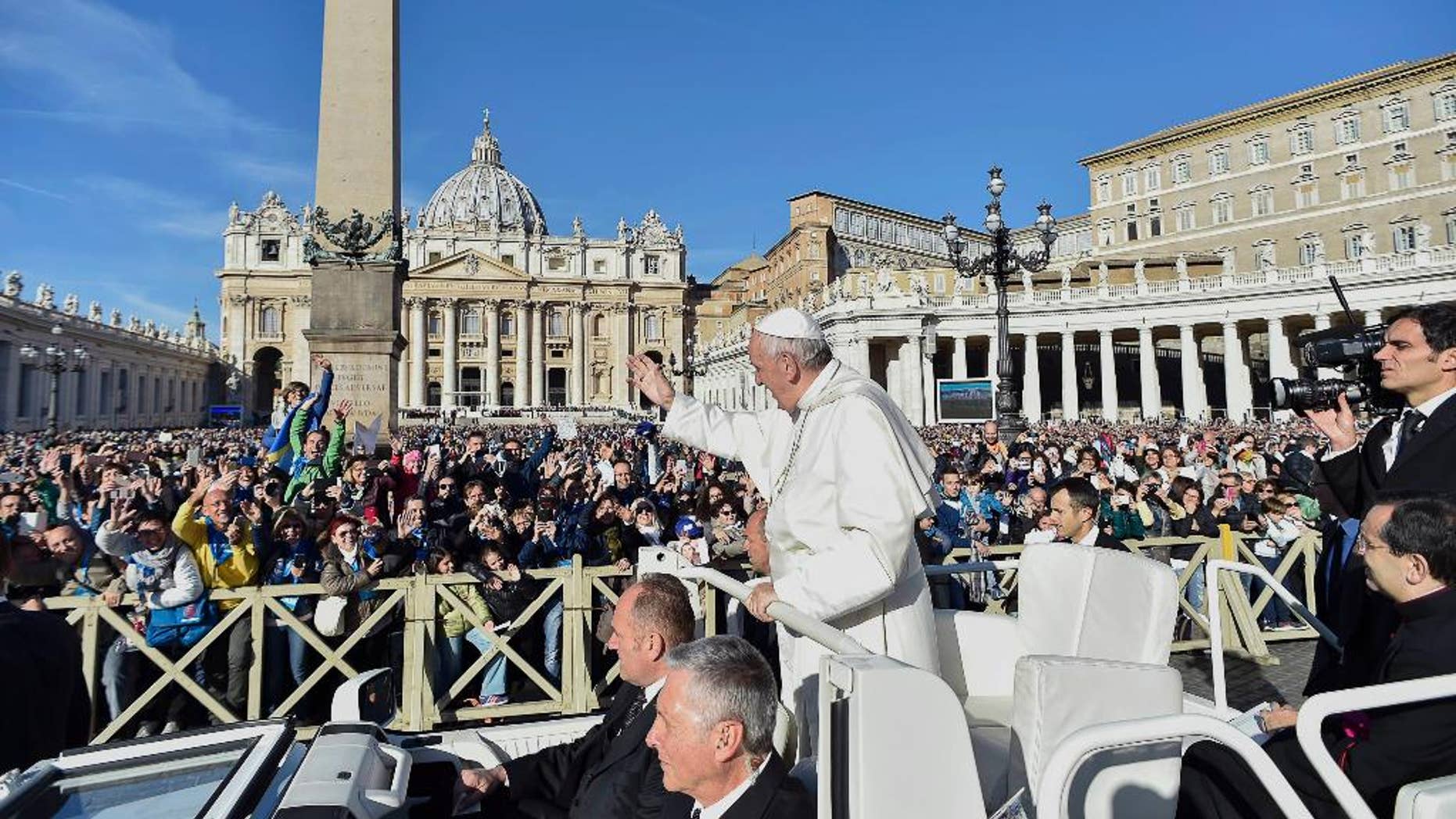 Pope Francis waves to faithful during a jubilee audience in St. Peter's Square, at the Vatican Saturday, Oct. 22, 2016. (L"osservatore Romano/Pool Photo via AP)