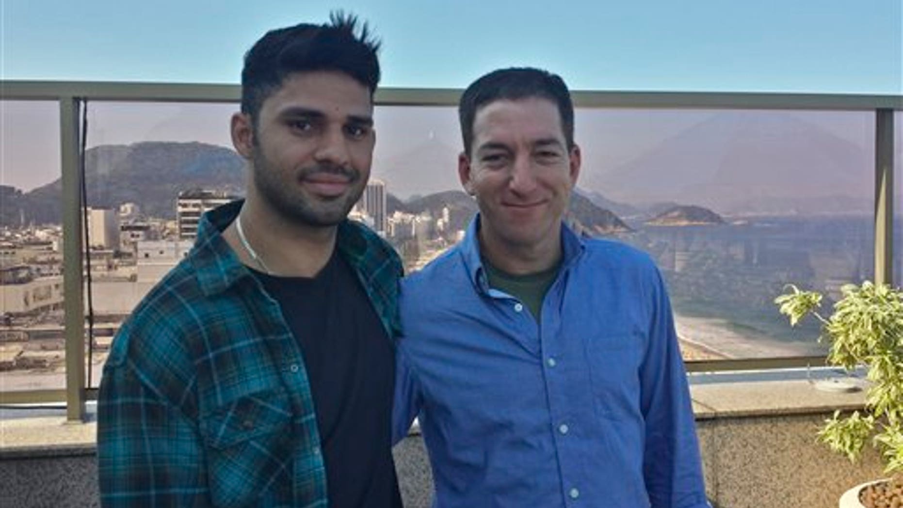 In this undated photo released by Janine Gibson of The Guardian, Guardian journalist Glenn Greenwald, right, and his partner David Miranda, are shown together at an unknown location. Miranda, the partner of Greenwald, a journalist who received leaks from former National Security Agency contractor Edward Snowden, was detained for nearly nine hours Sunday, Aug. 18, 2013, under anti-terror legislation at Heathrow Airport, triggering claims that authorities are trying to interfere with reporting on the issue. (AP Photo/Janine Gibson, the Guardian) CREDIT MANDATORY