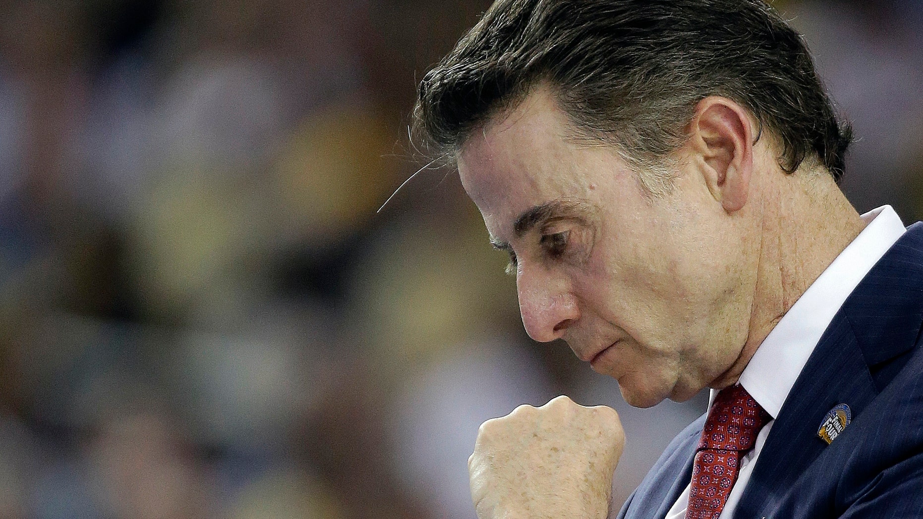 Louisville head coach Rick Pitino walks the court during the first half of a national semifinal at the Final Four of the NCAA college basketball game against Wichita State, Saturday, April 6, 2013, in Atlanta. (AP Photo/David J. Phillip)