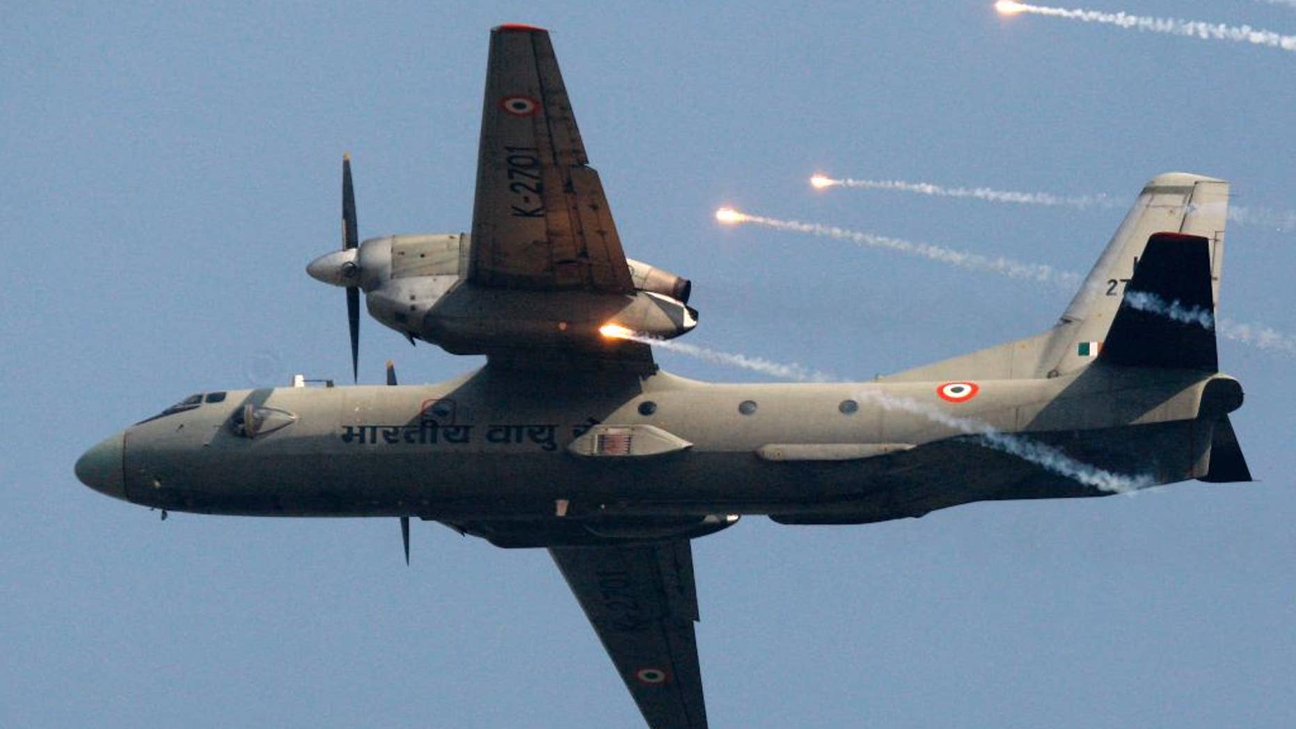 FILE- In this Thursday, Oct. 8, 2009, file photo, an Indian Air Force's (IAF) AN-32 transport aircraft releases chaff as it flies past the IAF Day Parade in New Delhi, India. A spokesman for India's defense ministry says the Indian air force has lost contact with a transport plane AN-32 with 29 people on board. A massive search by the air force, navy and coast guard has been launched. (AP Photo/Mustafa Quraishi, file)