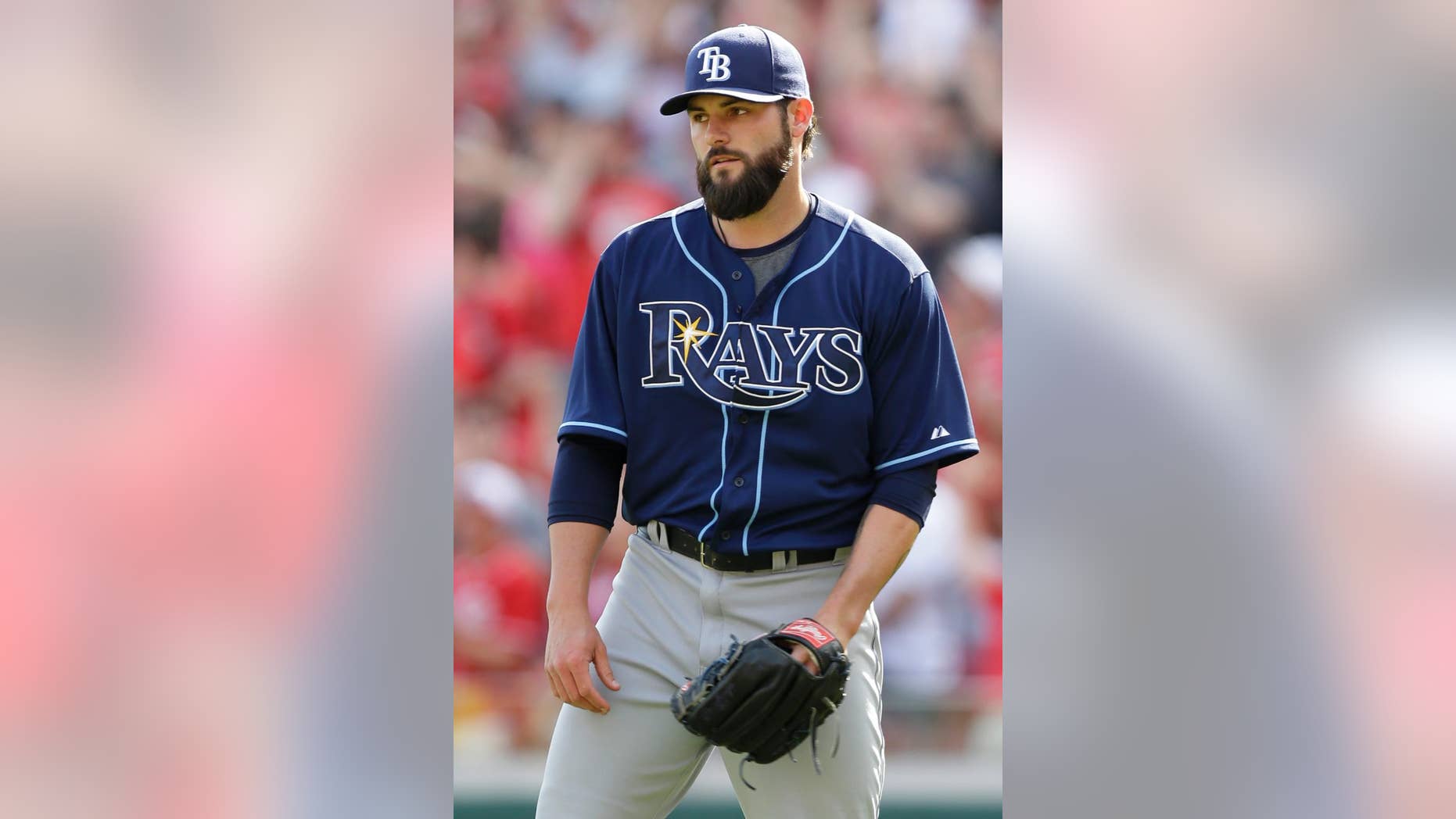 Tampa Bay Rays relief pitcher Josh Lueke turns toward the mound after giving up a pinch-hit grand slam to Cincinnati Reds' Chris Heisey in the eighth inning of a baseball game, Sunday, April 13, 2014, in Cincinnati. Cincinnati won 12-4. (AP Photo/Al Behrman)
