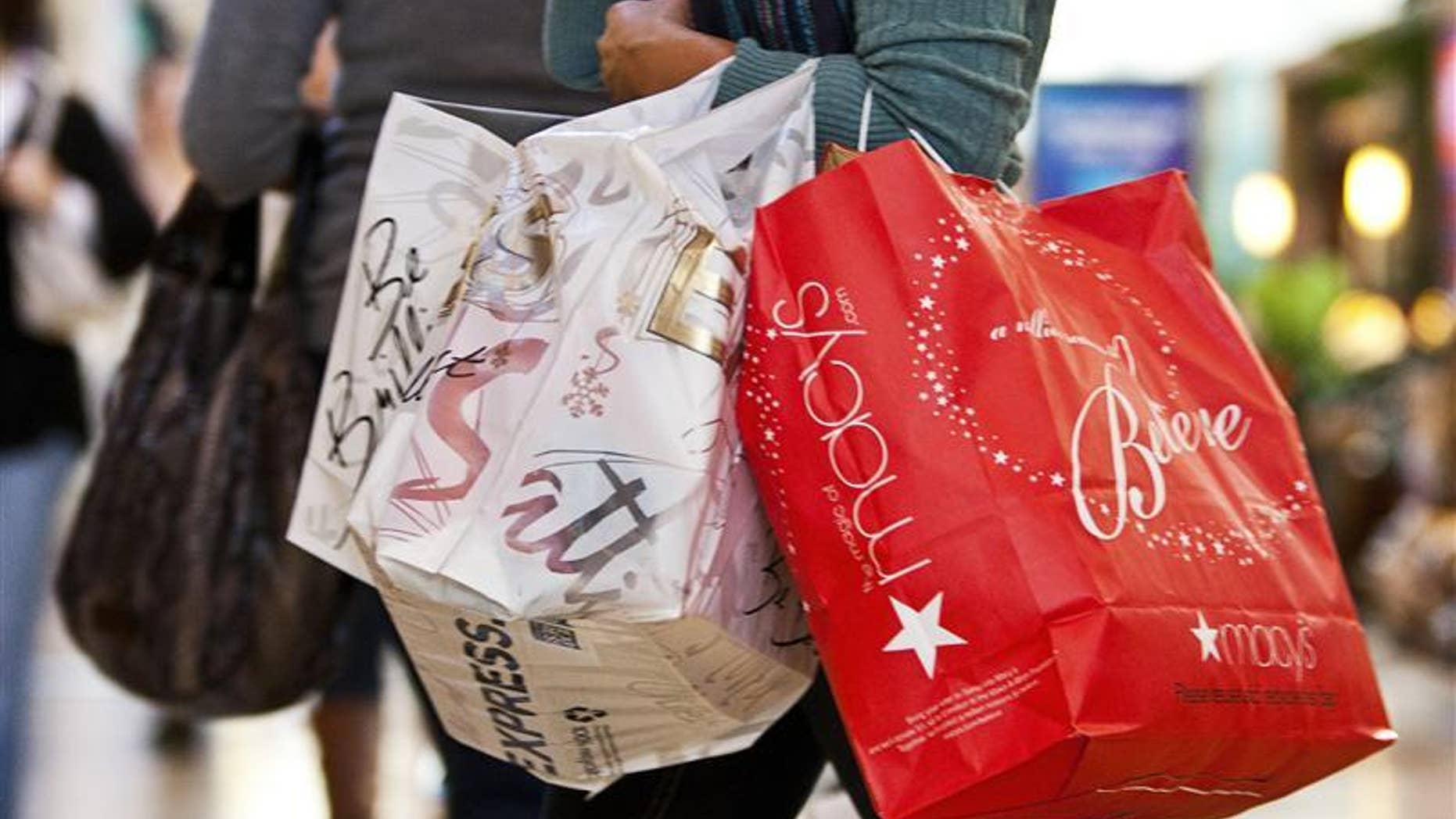 A customer carries shopping bags at South Park mall in Charlotte, North Carolina November 25, 2011. REUTERS/Chris Keane