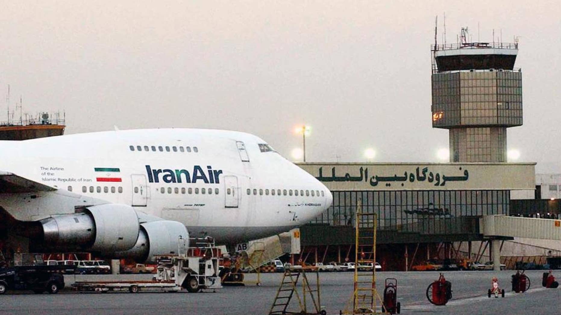 FILE - In this June 2003 file photo, a Boeing 747 of Iran's national airline is seen at Mehrabad International Airport in Tehran. Iran said Sunday it has finalized a $16.8 billion deal with Boeing to purchase 80 passenger planes, a deal made possible by last year's landmark nuclear agreement. (AP Photo/Hasan Sarbakhshian, File)
