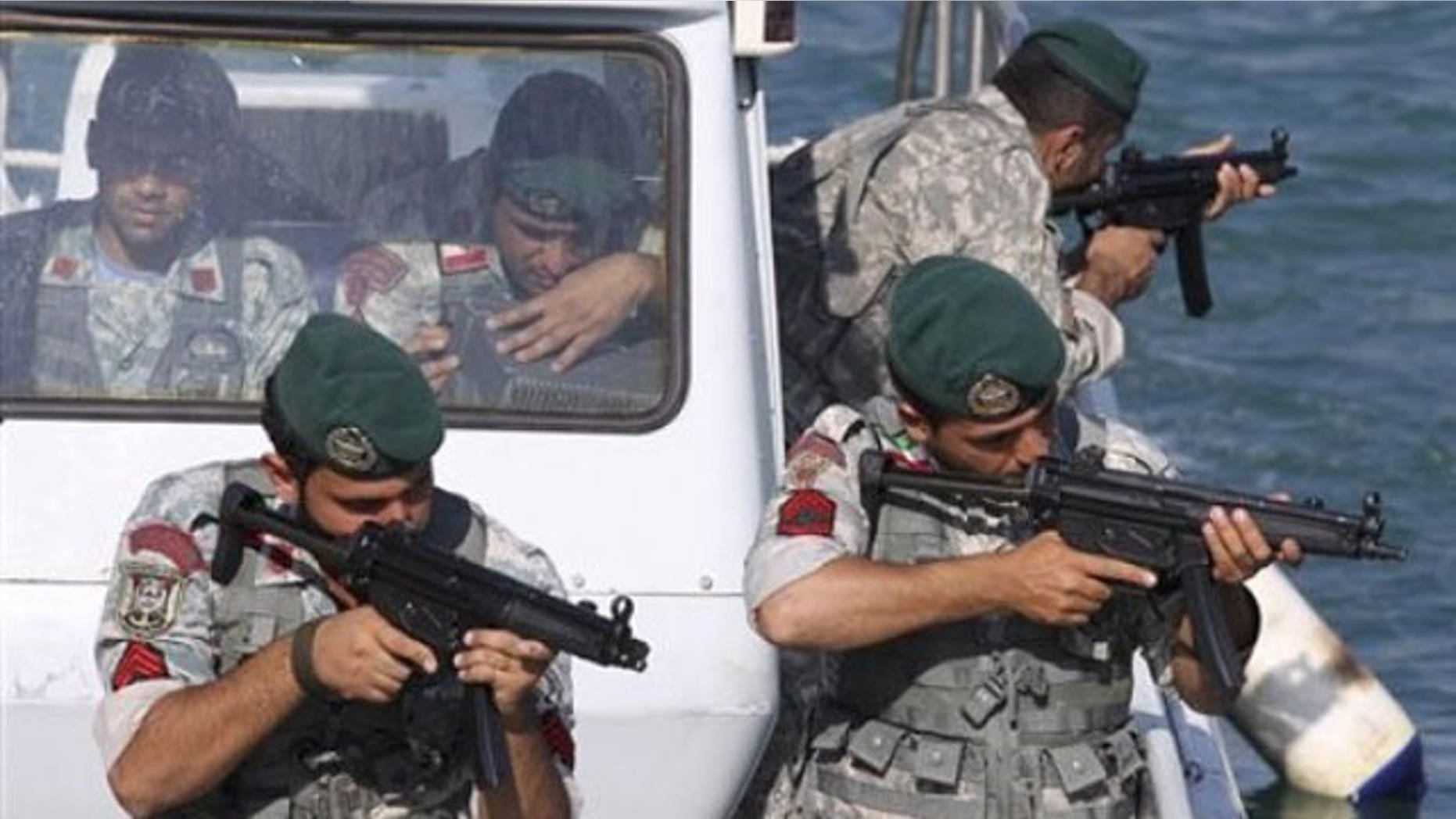 December 28, 2011: Iranian navy members take positions during a drill in the Sea of Oman.