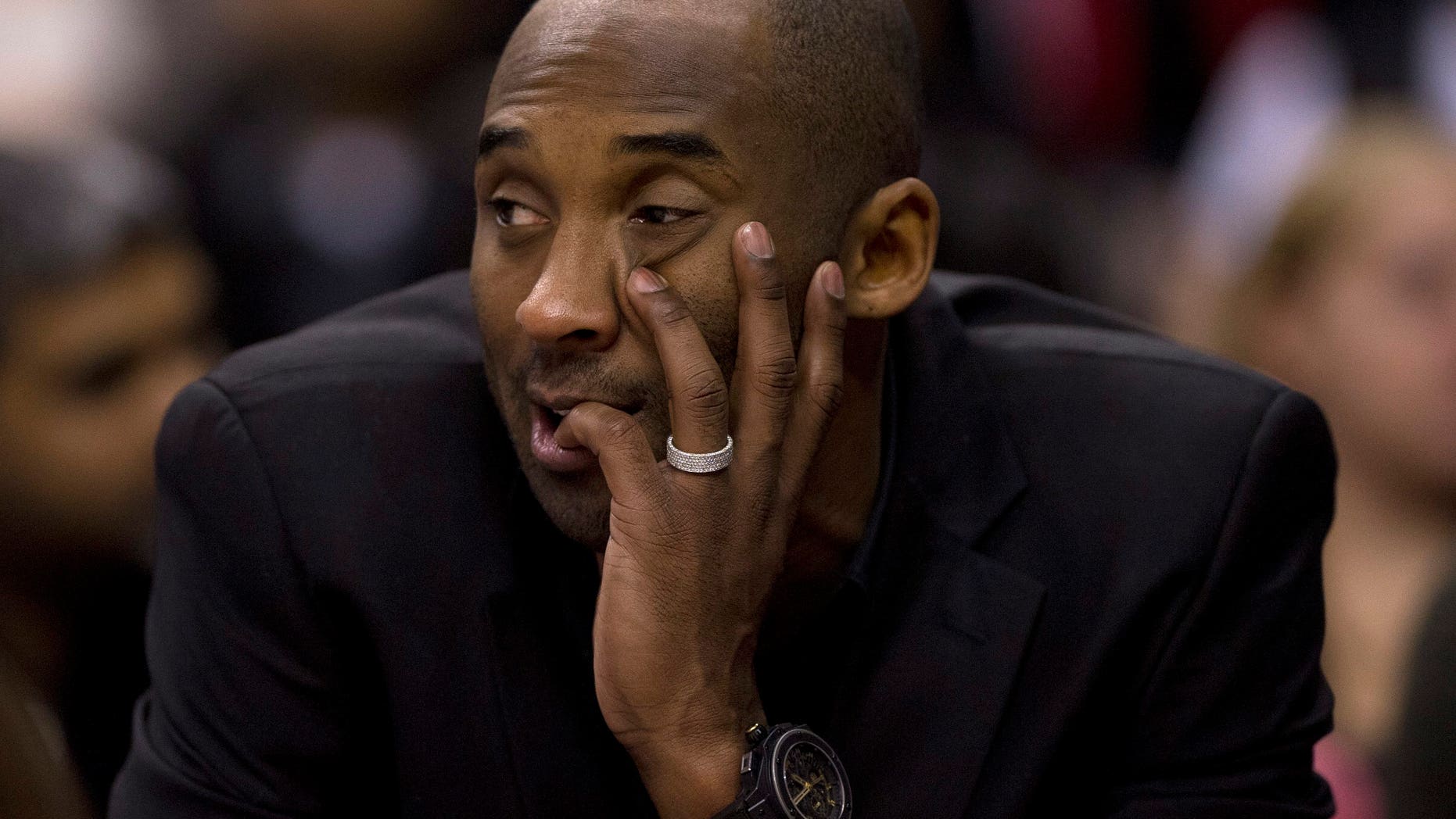Los Angeles Lakers' Kobe Bryant watches from the sideline during first-half NBA basketball game action against the Toronto Raptors in Toronto, Sunday, Jan. 19, 2014. Bryant injured his left knee in December. (AP Photo/The Canadian Press, Frank Gunn)
