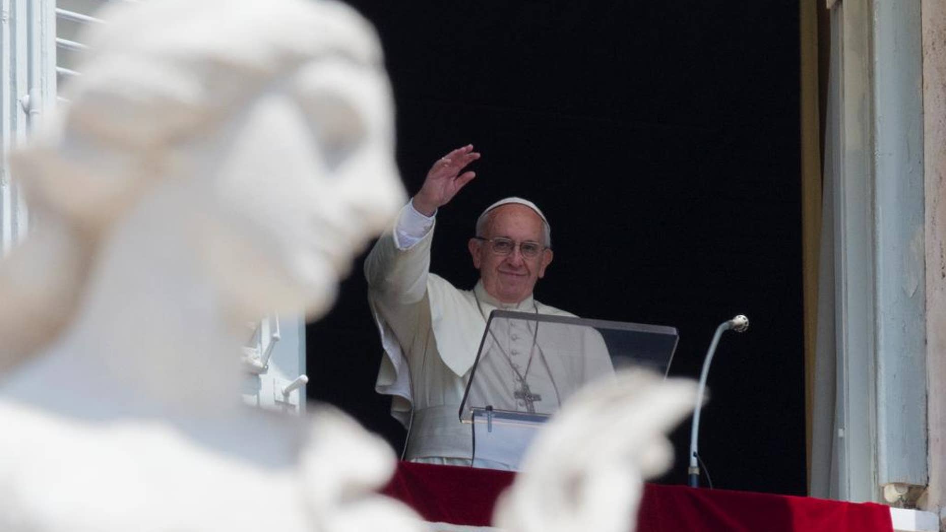 Pope Francis delivers his blessing during the Angelus noon prayer he celebrated from the window of his studio overlooking St. Peter's Square, at the Vatican, Sunday, July 10, 2016. (AP Photo/Andrew Medichini)