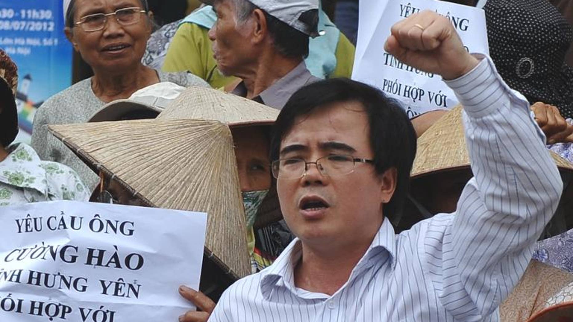 This picture taken on July 8, 2012 shows lawyer Le Quoc Quan (C) shouting during an anti-China rally in Hanoi