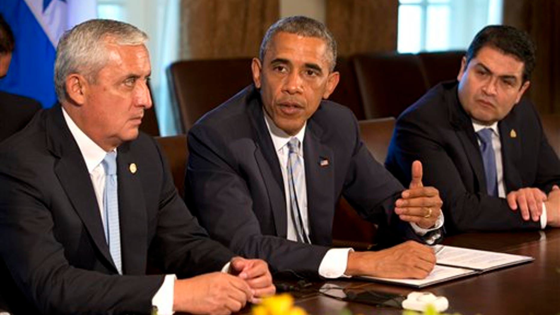 Guatemala's President Otto Perez Molina, left, and Honduran President Juan Hernandez, right, listen as U.S. President Barack Obama speaks to the media, after they met to discuss Central American immigration and the border crisis in the Cabinet Room of the White House Friday, July 25, 2014, in Washington. (AP Photo)
