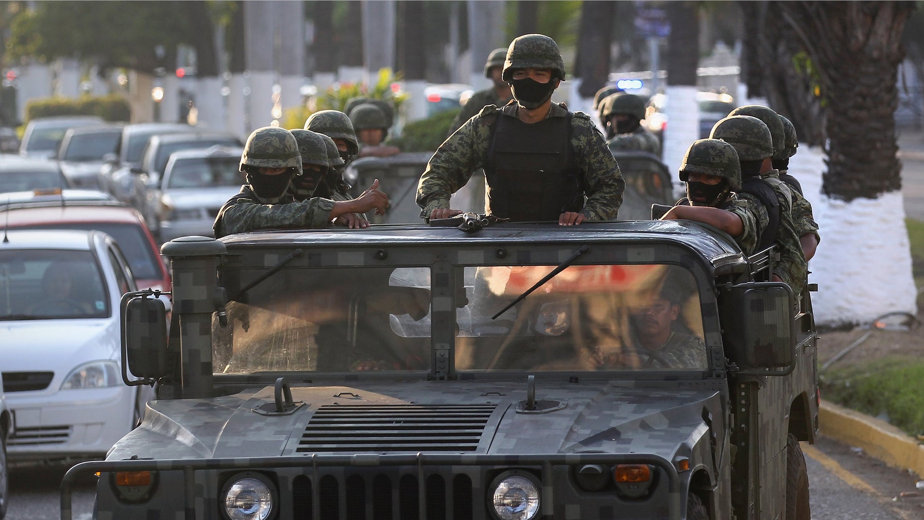 ACAPULCO, MEXICO - FEBRUARY 29: Mexican army soldiers patrol near the beach February 29, 2012 in Acapulco, Mexico. One of Mexico's top tourist destinations, Acapulco has suffered a drop in business, especially from foreign tourists, due to drug violence in the last year. Toursim accounts for some 9 percent of Mexico's economy and about 70 percent of the output of Acapulco's state of Guerrero. (Photo by John Moore/Getty Images)