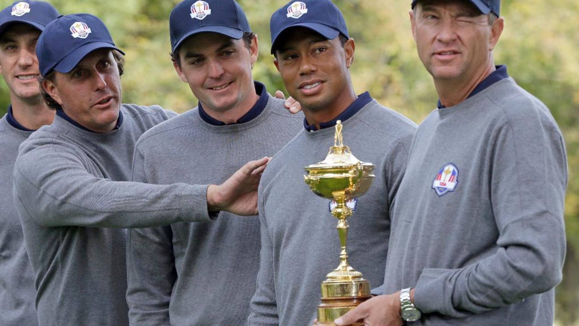 FILE - In this Sept. 25, 2012, file photo, USA's Phil Mickelson, left to right, Keegan Bradley, Tiger Woods and captain Davis Love III have some fun as they post for a picture at the Ryder Cup PGA golf tournament at the Medinah Country Club in Medinah, Ill. The PGA of America wants to take a closer look at its Ryder Cup failures. It is creating a task force that includes Tiger Woods and Phil Mickelson, along with three past captains of losing American teams. (AP Photo/Chris Carlson, File)