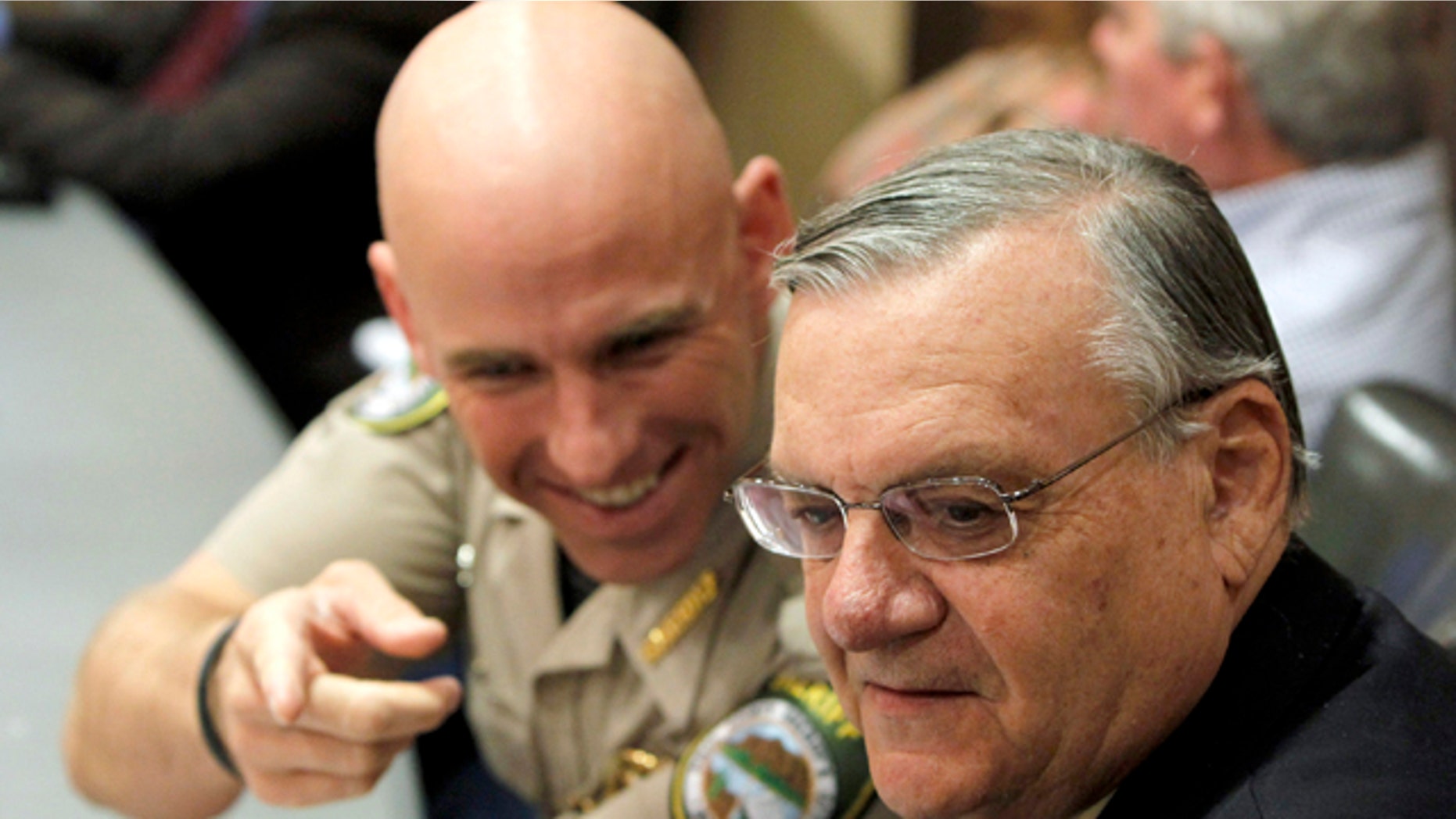 Pinal County Sheriff Paul Babeu, left, talks with Maricopa County Sheriff Joe Arpaio during a meeting last year. In response to a letter from three local mayors asking him to tone down his rhetoric, Babeu said his jurisdiction is the 'number one pass through county' nationwide for smuggling people and drugs. (AP)