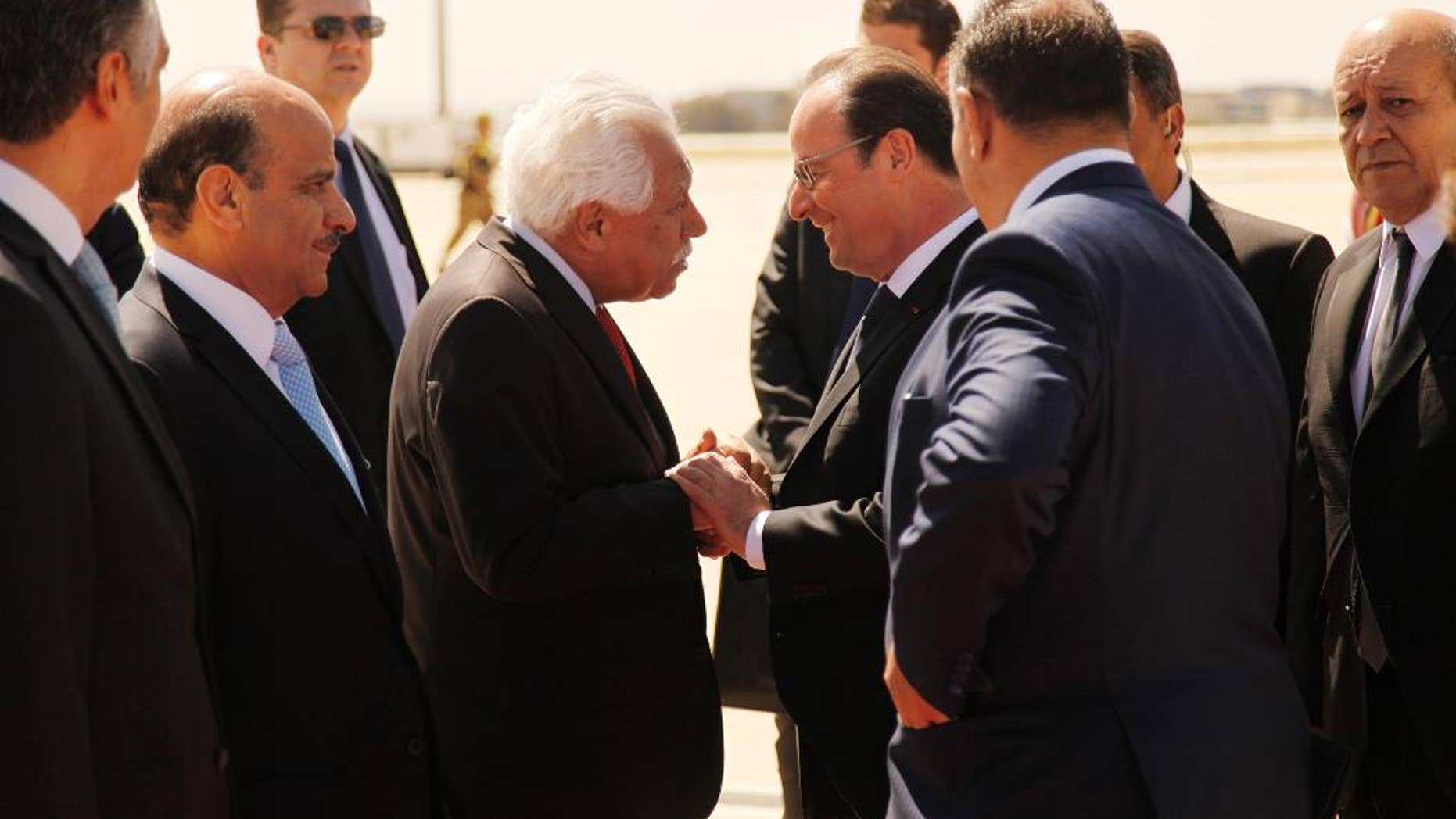 French President Francois Hollande, right, shakes the hand of Amman Mayor Aqel Biltaji after landing in Jordan on April 19, 2016 on the last leg of a Middle East tour including Lebanon and Egypt. (AP Phoro/ Sam McNeil)
