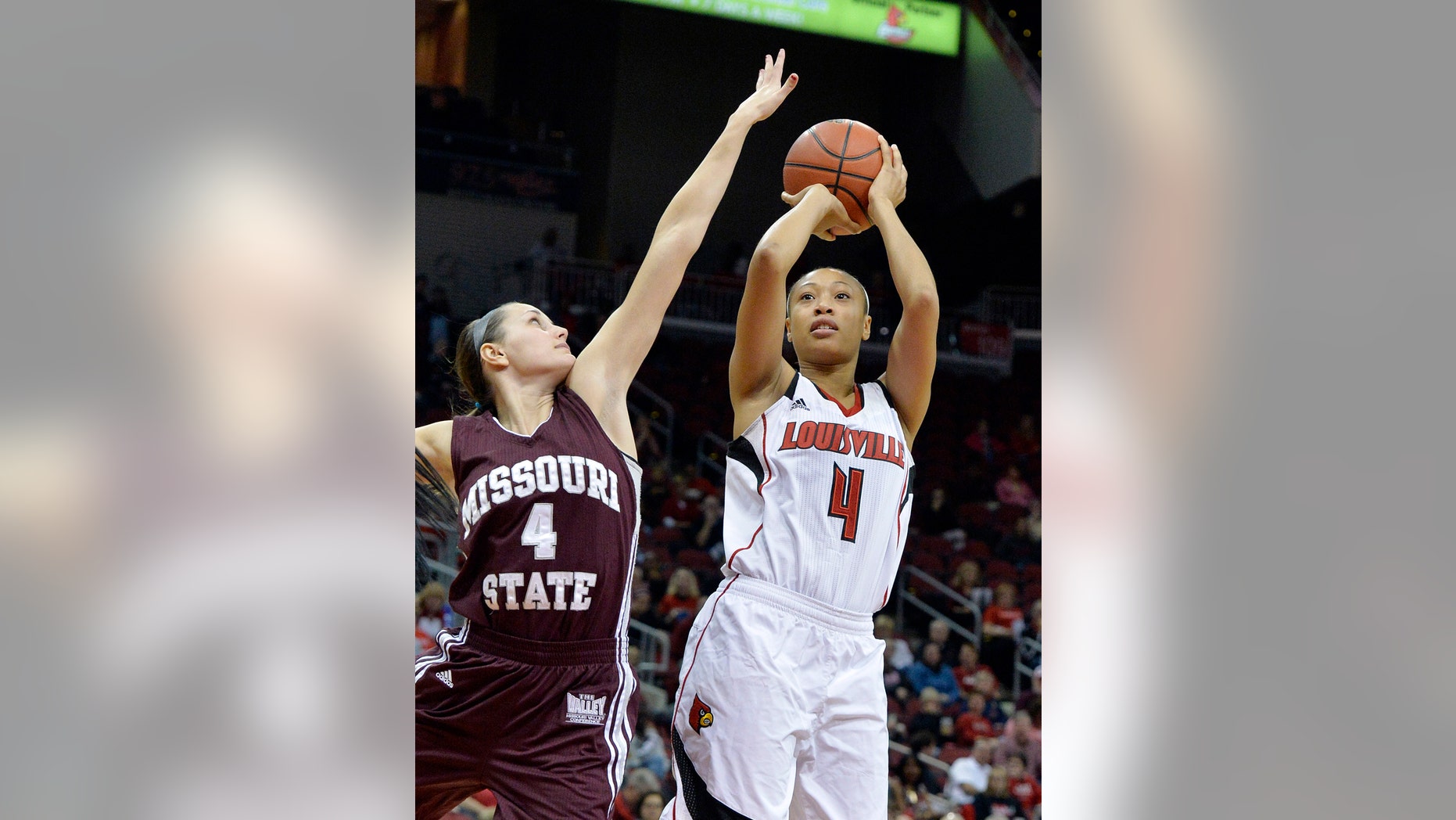 Louisville's Antonita Slaughter, right, gets a shot off over the defense of Missouri State's Kenzie Williams during the first half of an NCAA college basketball game Tuesday, Dec. 3, 2013, in Louisville, Ky. (AP Photo/Timothy D. Easley)