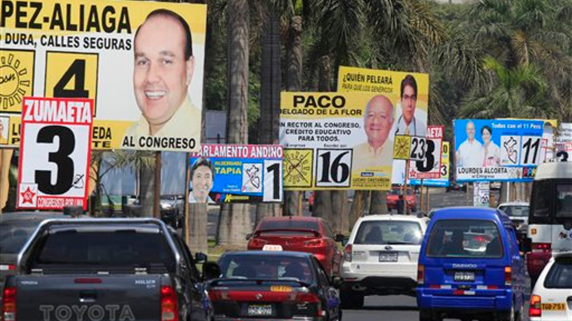 Cars drive past political campaign signs in Lima, Peru, Saturday April 9, 2011. (AP Photo/Martin Mejia)