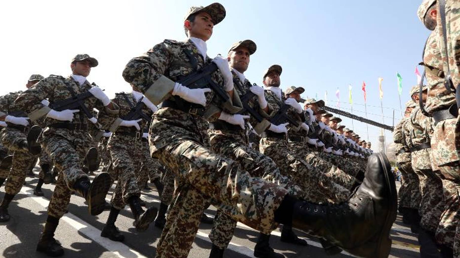 Iranian soldiers march past President Hassan Rowhani during an annual military parade in Tehran, on September 22, 2013
