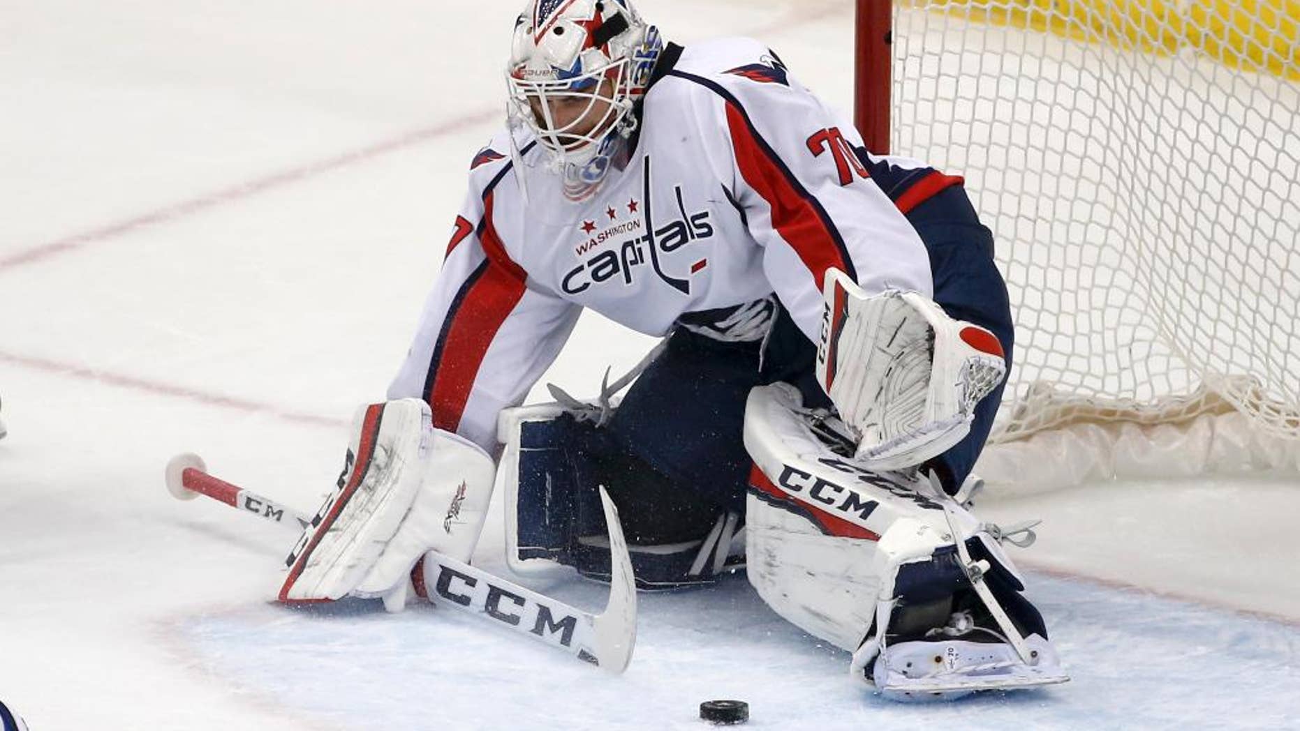 In this photo taken March 20, 2016, Washington Capitals goalie Braden Holtby (70) plays during an NHL hockey game against the Pittsburgh Penguins in Pittsburgh. Holtby is on the verge of tying Martin Brodeur's single-season record of 48 wins with time left to break it. As goalies with 40-plus-win seasons know, it takes a heavy workload, a great team and some luck to make it happen. (AP Photo/Gene J. Puskar)