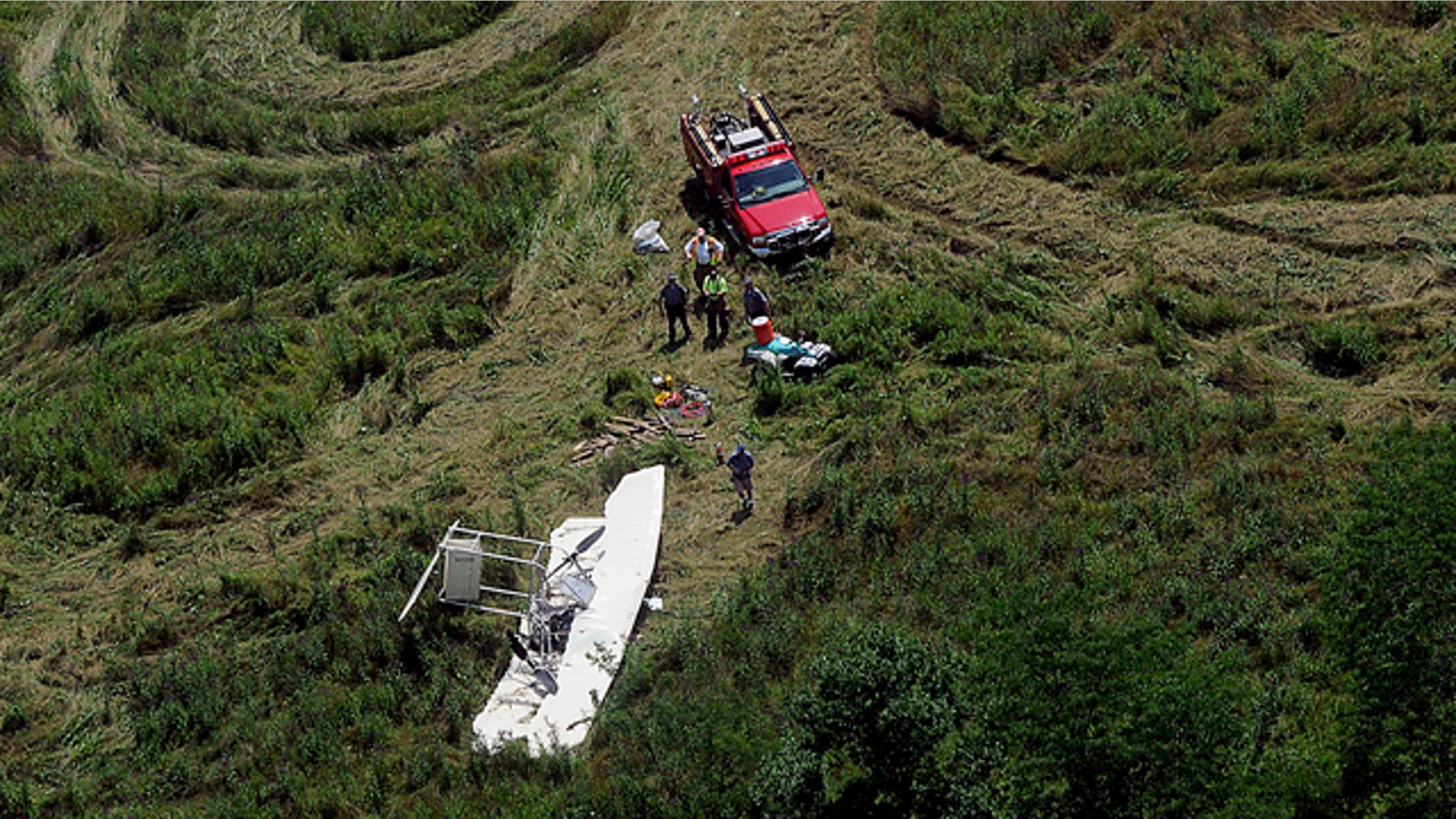 July 30: Officials inspect the scene of a small plane crash about near Springfield, Ohio.