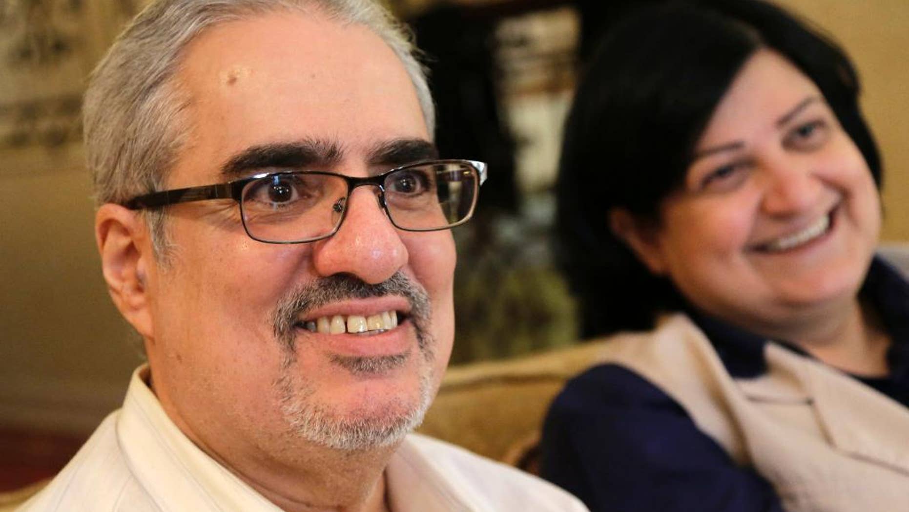 FILE -- In this June 20, 2015 file photo, Bahraini Sunni Muslim opposition leader Ibrahim Sharif, who led the secular opposition WAAD (National Democratic Action Society) group, sits with his wife Farida Ghulam at their home, in Tubli, Bahrain. The Bahrain Institute for Rights and Democracy, a Bahraini rights group, said political activist Ibrahim Sharif has been freed from prison Monday, July 11, 2016, after serving a yearlong sentence over comments he made last year. The rights group said Sharif was released but is at risk of being arrested again because of an appeal by prosecutors, who are seeking an extended sentence. (AP Photo/Hasan Jamali, File)