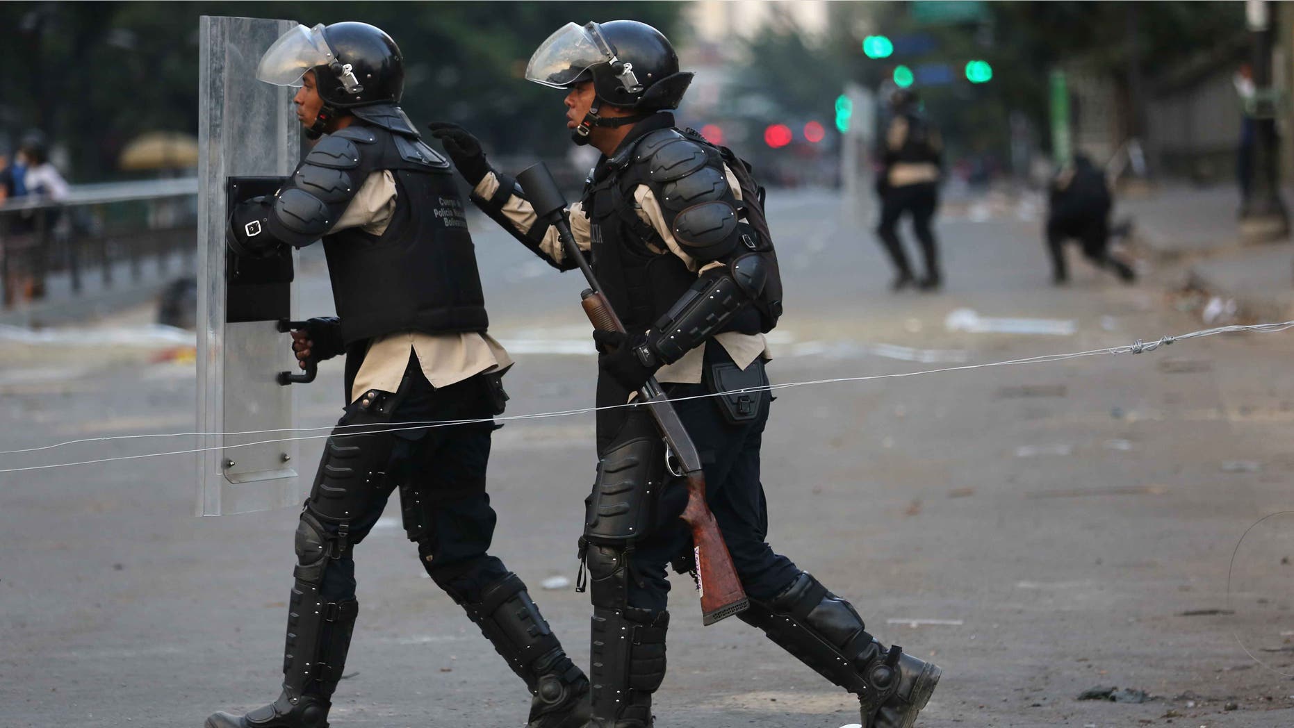 CARACAS, VENEZUELA - MARCH 06: Venezuelan national policemen advance on anti-government demonstrators on March 6, 2014 in Caracas, Venezuela. Protesters continued to stage demonstrations nationwide against high inflation and crime. (Photo by John Moore/Getty Images)