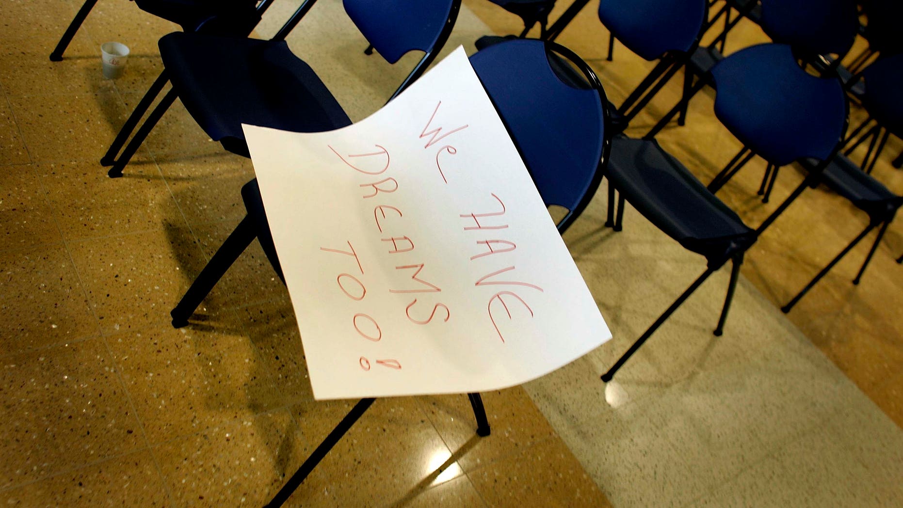 MIAMI - MARCH 12: A sign with the words, " We have dreams too!", lays on a chair after a press conference to announce The American Dream Act March 12, 2007 at Florida International University in Miami, Florida. The bill, if passed in the United States Congress, would allow for undocumented immigrant students to obtain in-state tuition as well as permit those students, along with those serving in the military, to obtain a green card and legally remain in the United States. (Photo by Joe Raedle/Getty Images)