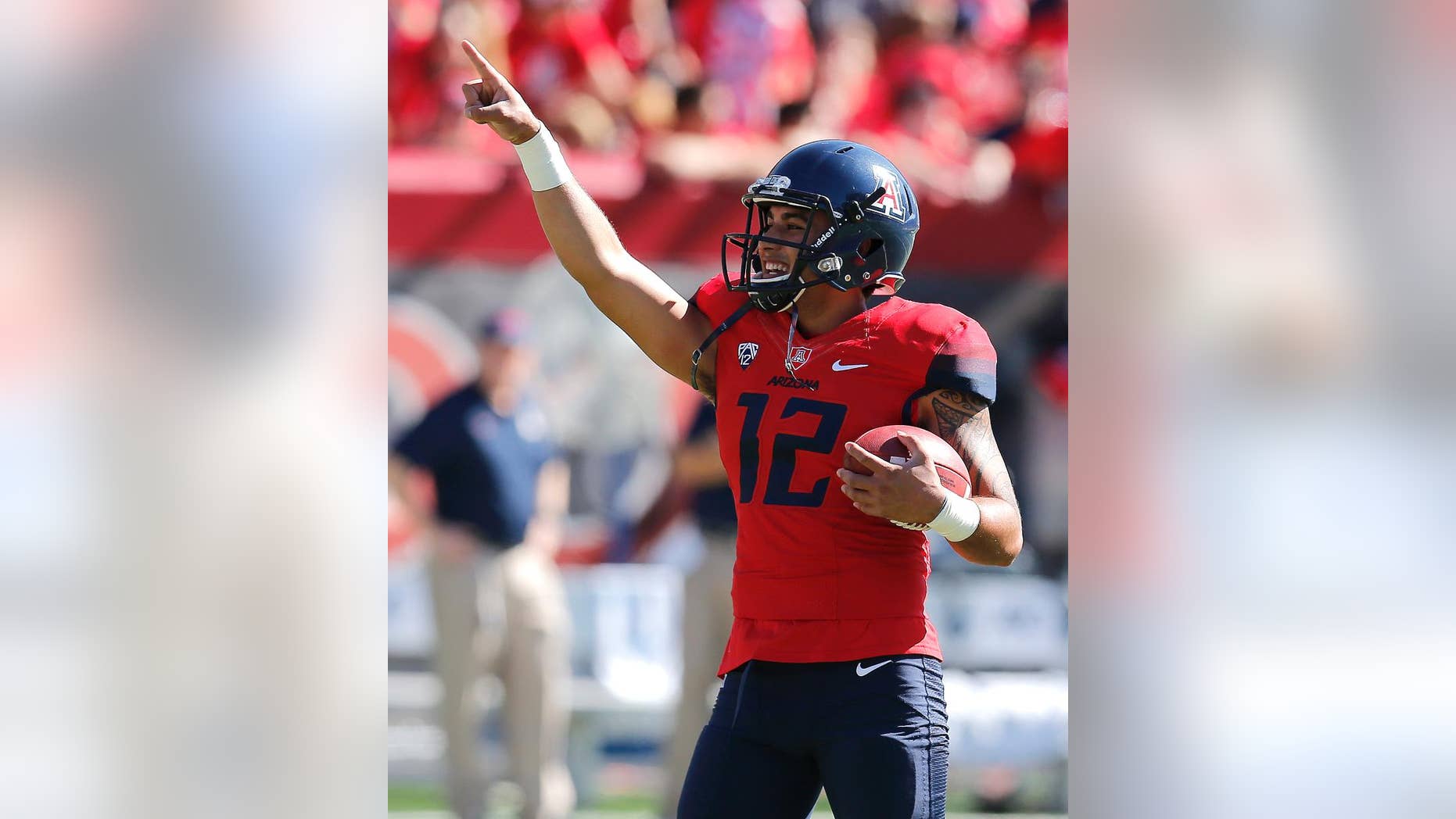 Arizona quarterback Anu Solomon (12) warms up before an NCAA college football game against Washington, Saturday, Nov. 15, 2014, in Tucson, Ariz. (AP Photo/Rick Scuteri)