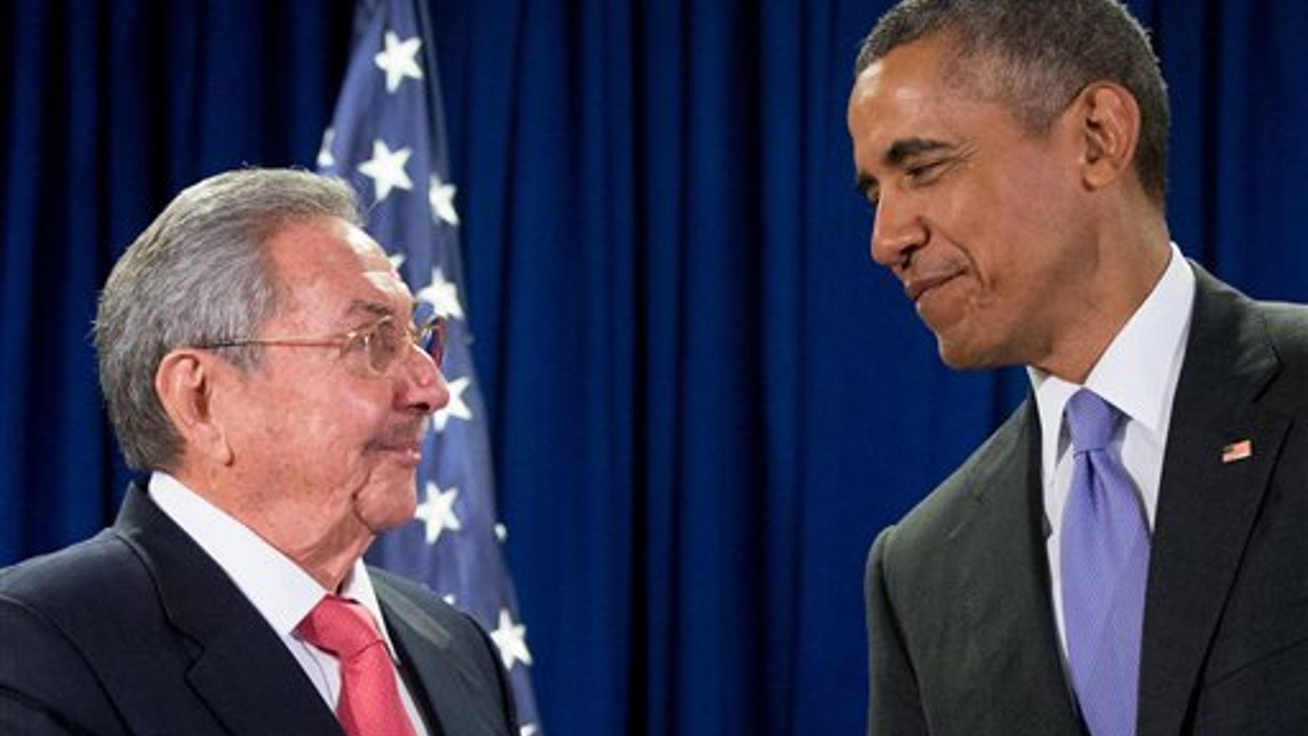 FILE - In this Sept. 29, 2015 file photo, President Barack Obama stands with Cuba's President Raul Castro before a bilateral meeting at the United Nations headquarters. President Barack Obama will use his historic trip to Cuba to chip away at key remaining U.S. obstacles to travel and commerce with the communist island, working to push his rapprochement past the point of no return before he leaves office. (AP Photo/Andrew Harnik, File)