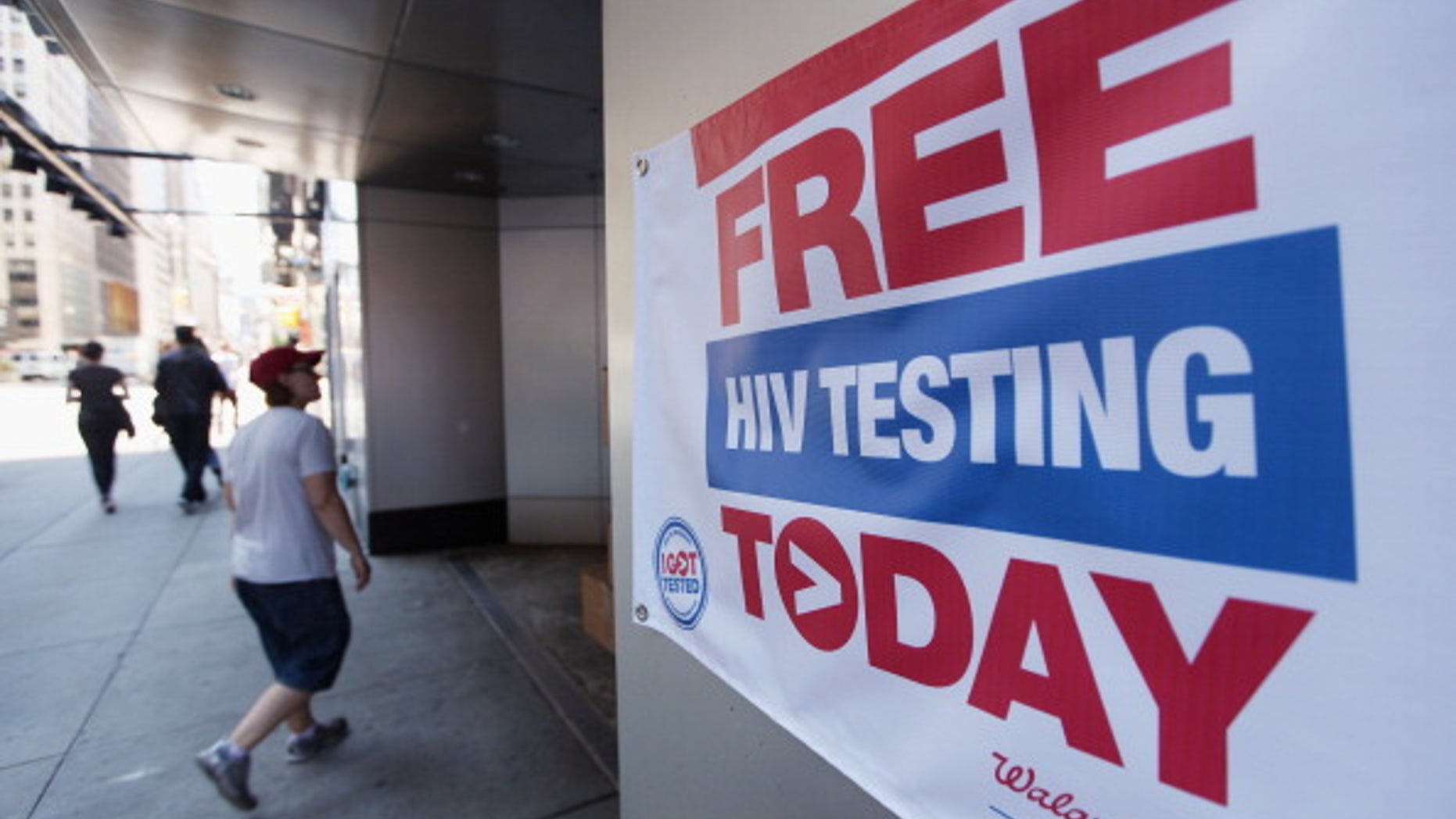 A sign for free HIV testing is seen outside a Walgreens pharmacy in Times Square in New York City.