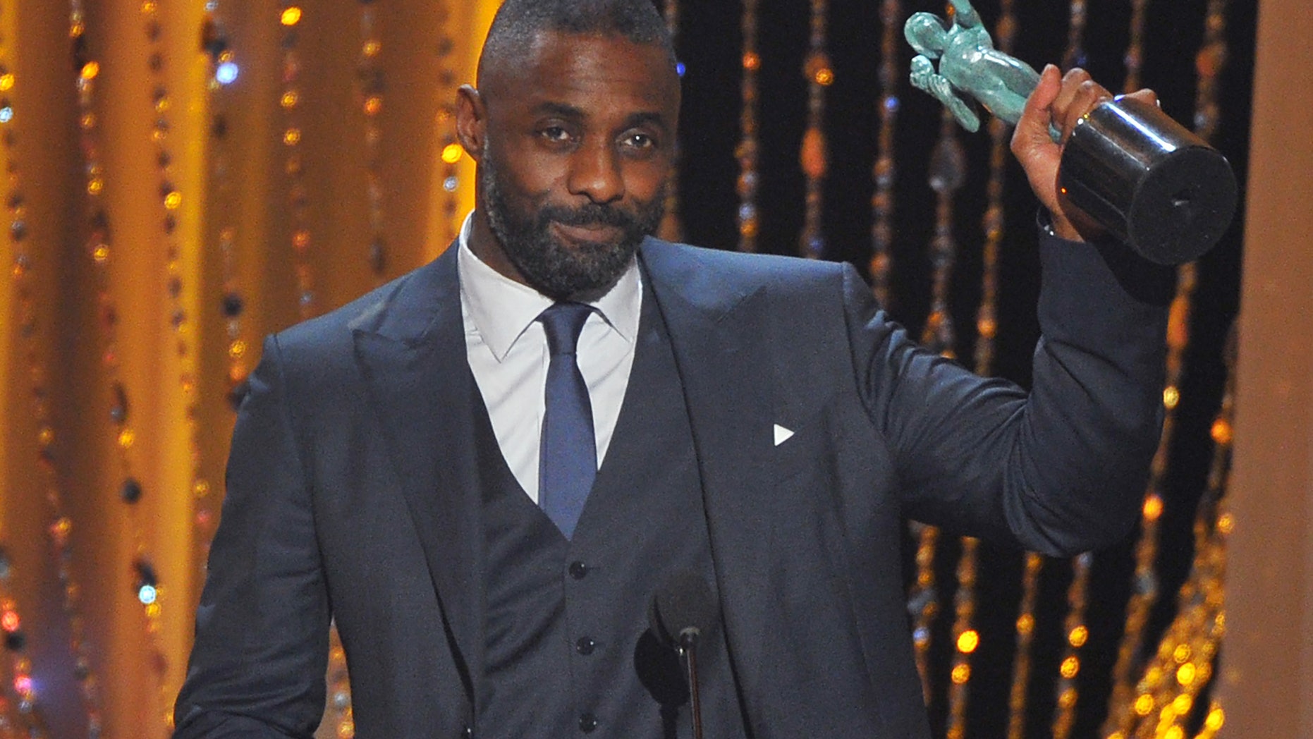 Idris Elba accepts the award for outstanding male actor in a supporting role for Beasts of No Nation at the 22nd annual Screen Actors Guild Awards.