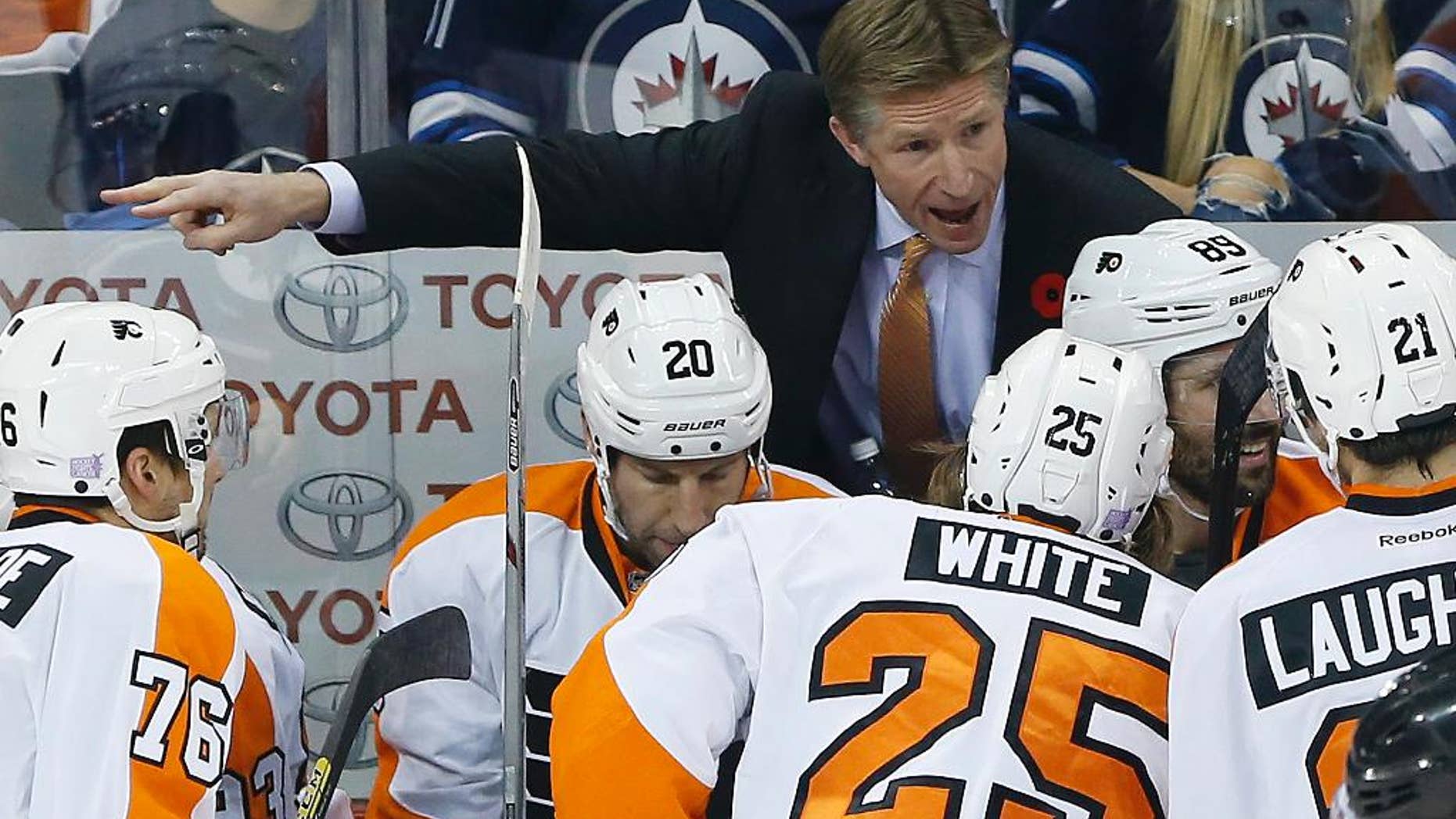 FILE - In this Nov. 7, 2015, file photo, Philadelphia Flyers head coach Dave Hakstol,top, speaks to his players during the first period of NHL hockey game against the Winnipeg Jets in Winnipeg, Manitoba. Last summer Hakstol became the first college hockey coach to get hired by an NHL team in almost 30 years. His success in his first season with the Flyers almost certainly means it won't be another 30 years until the next one. (John Woods/The Canadian Press via AP, File)