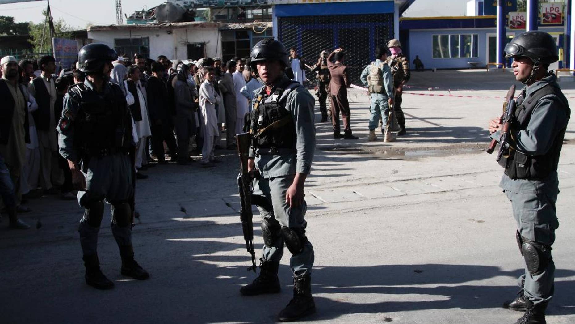 Afghan police soldiers inspect the site of a suicide attack in Kabul, Afghanistan, Monday, June 20, 2016. At least a dozen Nepalese security guards of a foreign logistic company were killed Monday when a Taliban suicide bomber targeted their minibus in the Afghan capital, interior ministry and an Afghan security official said. (AP Photo/Rahmat Gul)