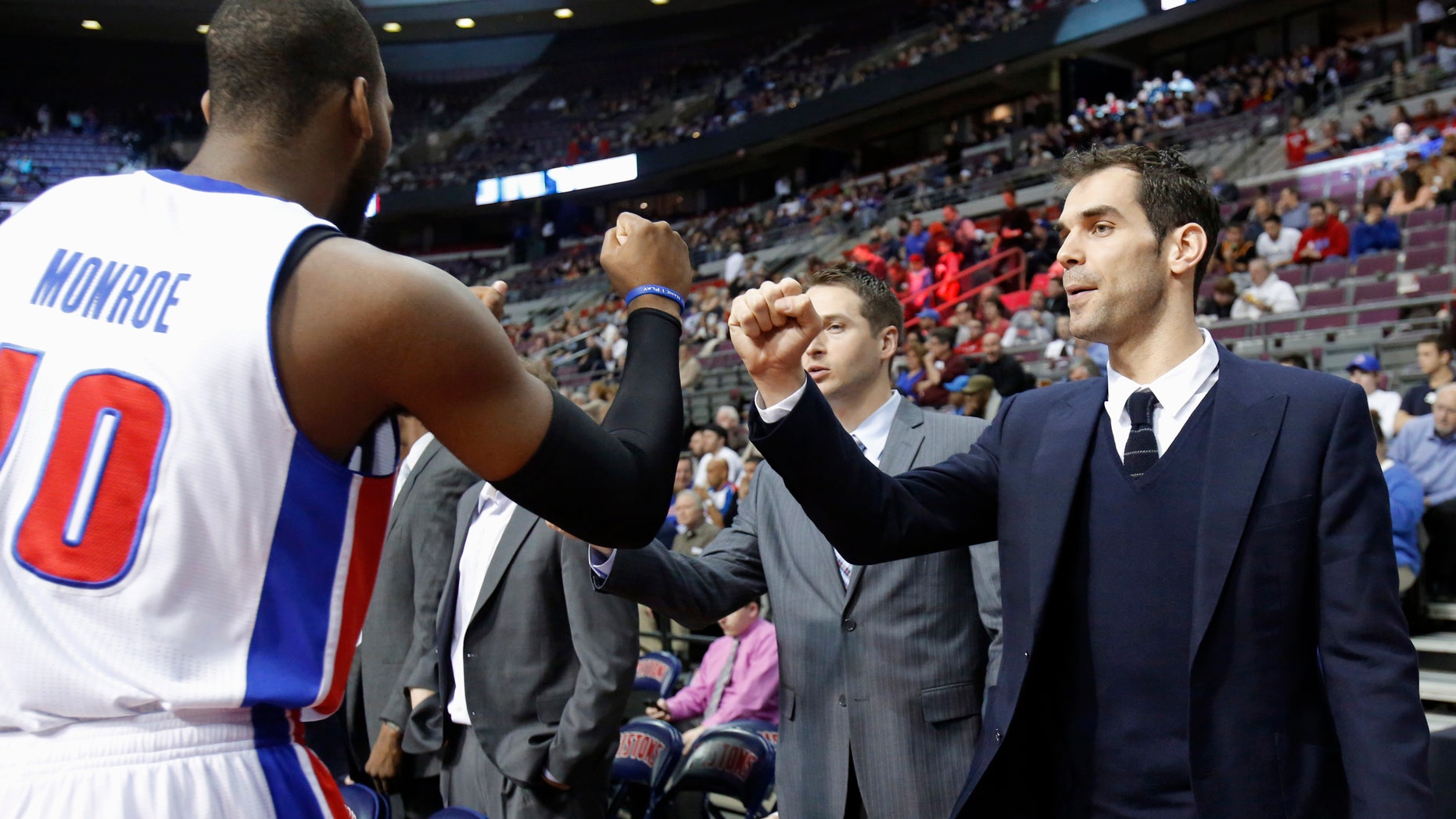 Detroit Pistons guard Jose Calderon, right, gets a fist bump from center Greg Monroe (10) before the Pistons' NBA basketball game against the Cleveland Cavaliers on Friday, Feb. 1, 2013, in Auburn Hills, Mich. Calderon was acquired in a trade from the Toronto Raptors but did not play Friday. (AP Photo/Duane Burleson)
