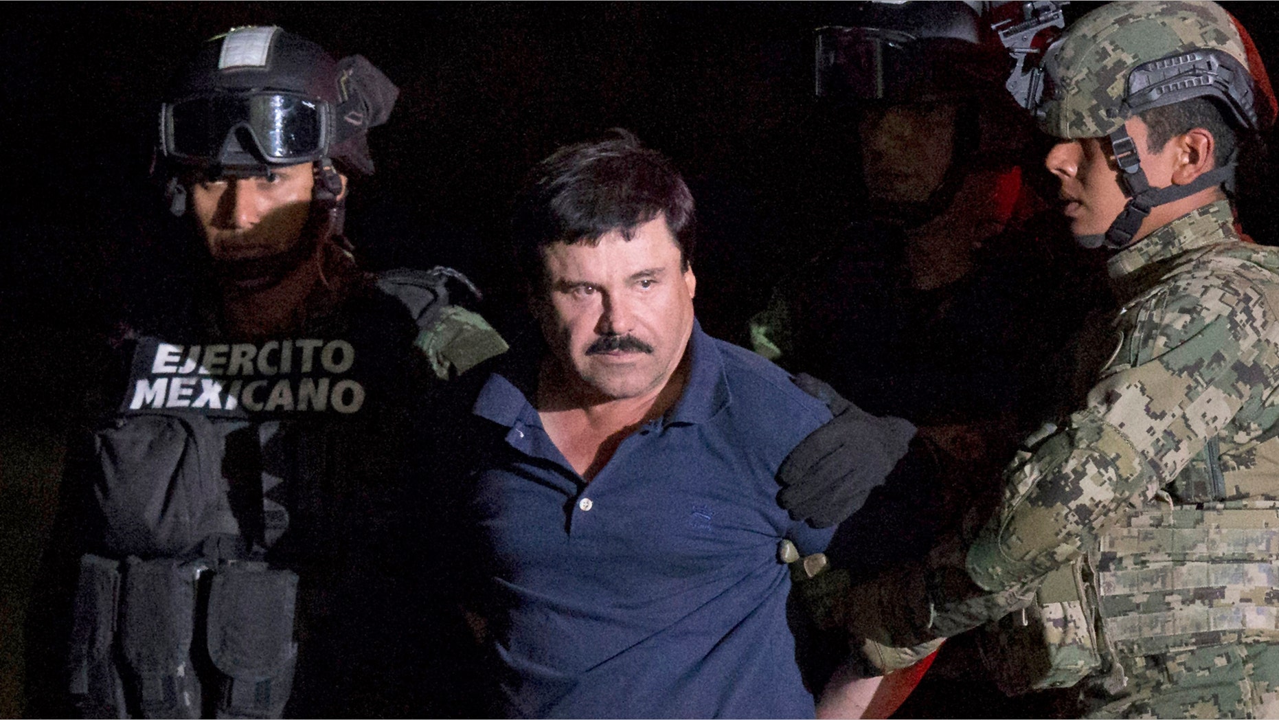 FILE - In this Jan. 8, 2016 file photo, Mexican drug lord Joaquin "El Chapo" Guzman is escorted by army soldiers to a waiting helicopter, at a federal hangar in Mexico City, after he was recaptured from breaking out of a maximum security prison in Mexico. The History channel says it's developing a drama series focusing on Guzman's story. Last year, Guzman had broken out of prison and was on the run when he had a secret meeting with Mexican actress Kate del Castillo and Sean Penn. The actor wrote about it for Rolling Stone. (AP Photo/Rebecca Blackwell, File)