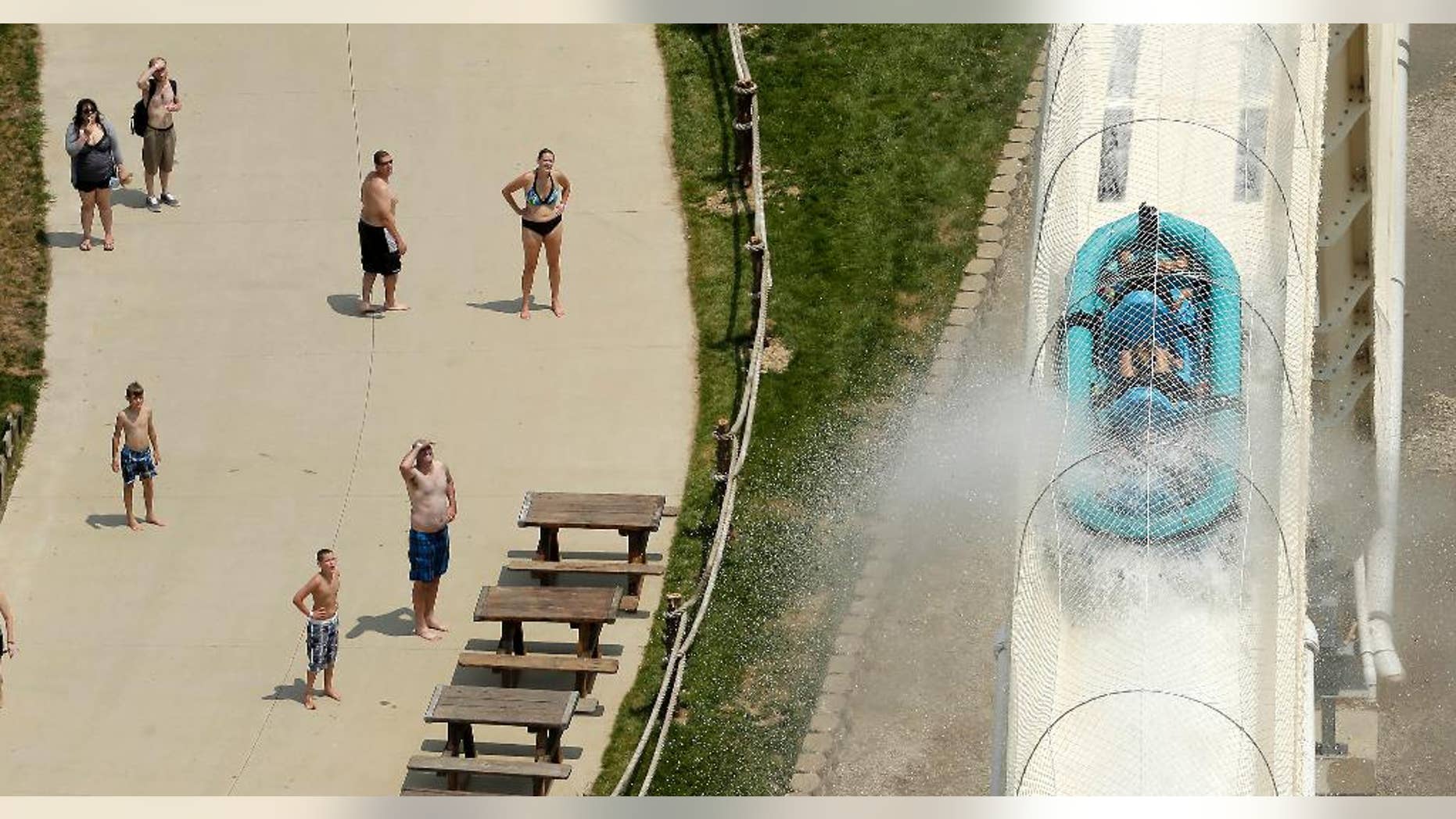 FILE - In this July 9, 2014, file photo, riders are propelled by jets of water as they go over a hump while riding a waterslide called "Verruckt" at Schlitterbahn Waterparks and Resorts in Kansas City, Kan. The Verruckt waterslide, on which a state lawmaker's 10-year-old son was killed Aug 7, 2016, will be demolished once the unfolding investigation of the tragedy is finished, the water park's operators said Tuesday, Nov. 22, 2016. (AP Photo/Charlie Riedel, File)