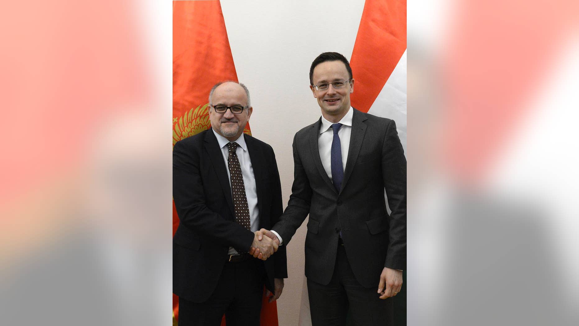 Montenegrin Foreign Minister Srdjan Darmanovic, left, and Hungarian Minister of Foreign Affairs and Trade Peter Szijjarto shake hands during their meeting in the Ministry of Foreign Affairs and Trade in Budapest, Hungary, Friday, Jan. 27, 2017. (Lajos Soos/MTI via AP)