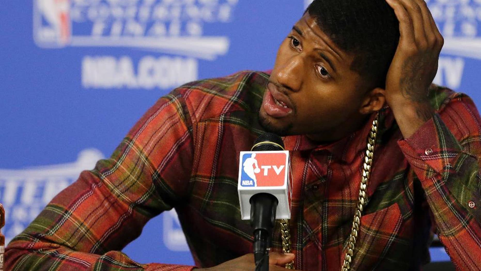 Indiana Pacers forward Paul George speaks during the post-game news conference after Game 4 in the NBA basketball Eastern Conference finals playoff series, Tuesday, May 27, 2014, in Miami. The Heat won 102-90. (AP Photo/Wilfredo Lee)