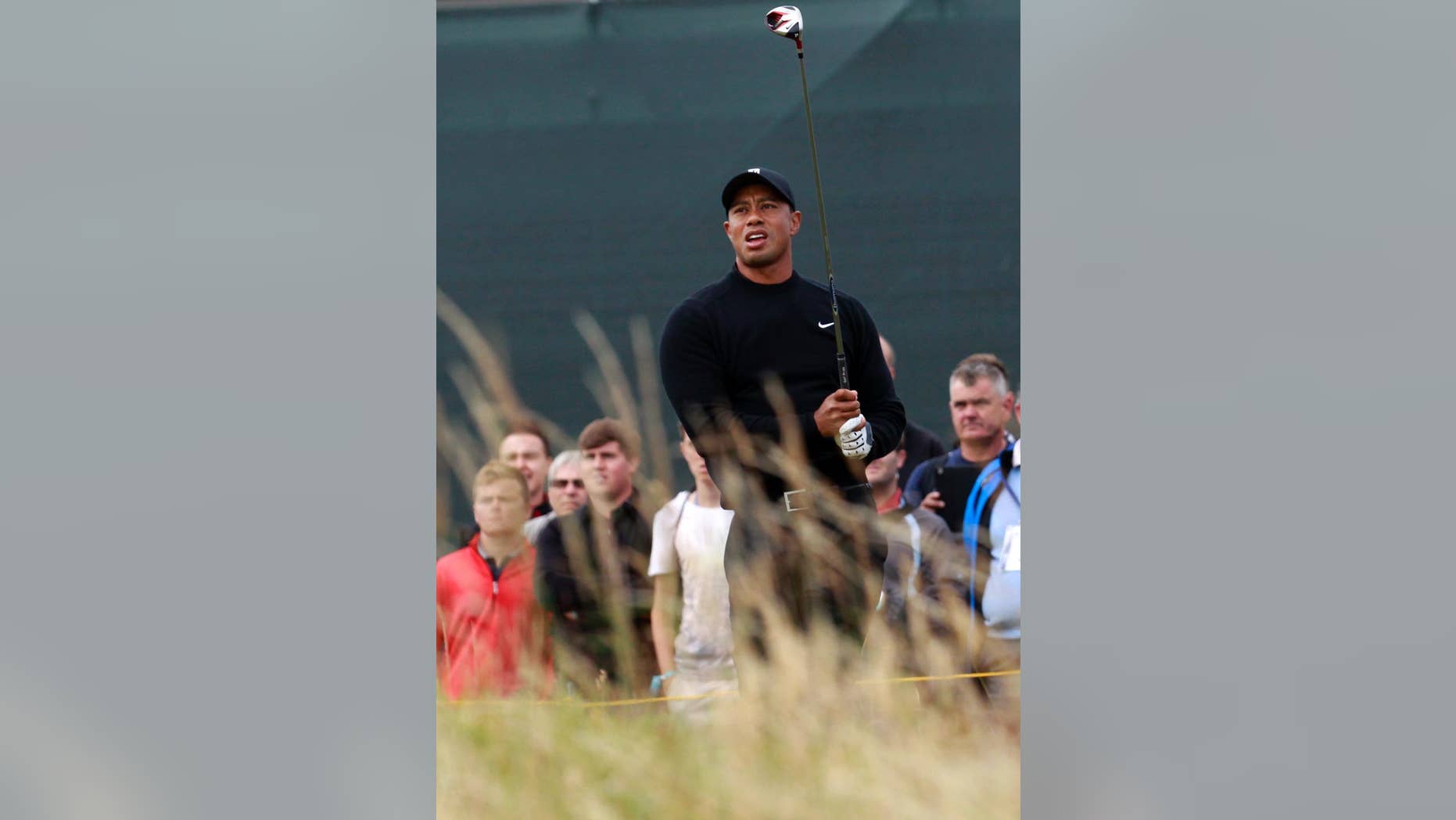 Tiger Woods of the US watches his shot off the 5th tee during a practice round ahead of the British Open Golf championship at the Royal Liverpool golf club, Hoylake, England, Tuesday July 15, 2014. The British Open starts on Thursday July 17. (AP Photo/Peter Morrison)